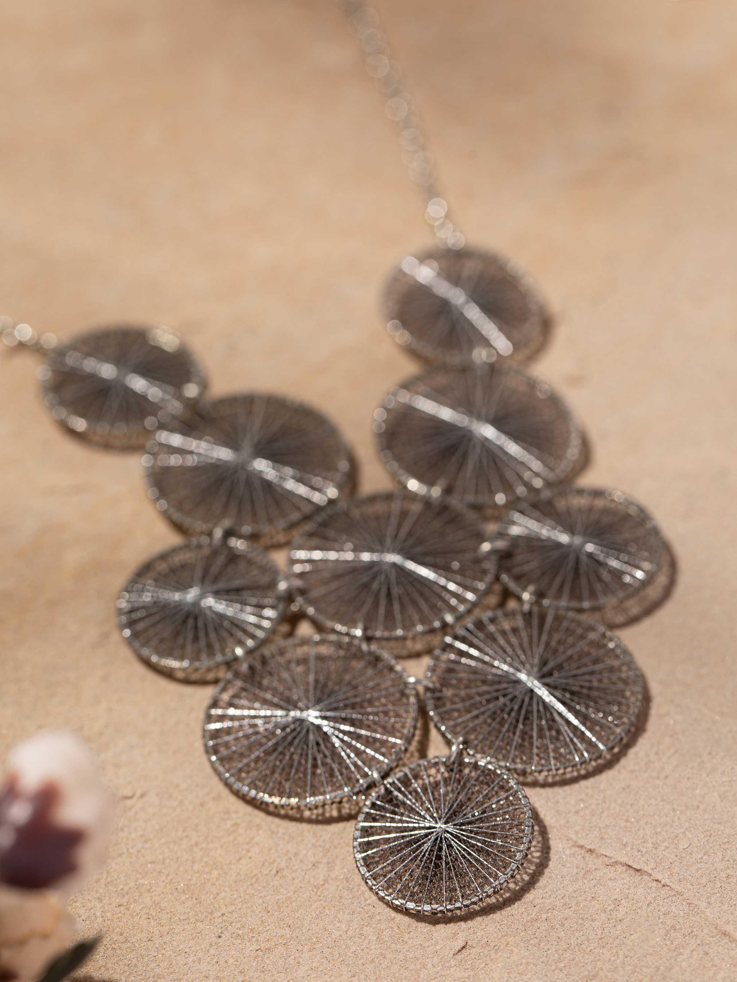 Back view of String Craft Long Necklace showing the clasp and detailed string design.