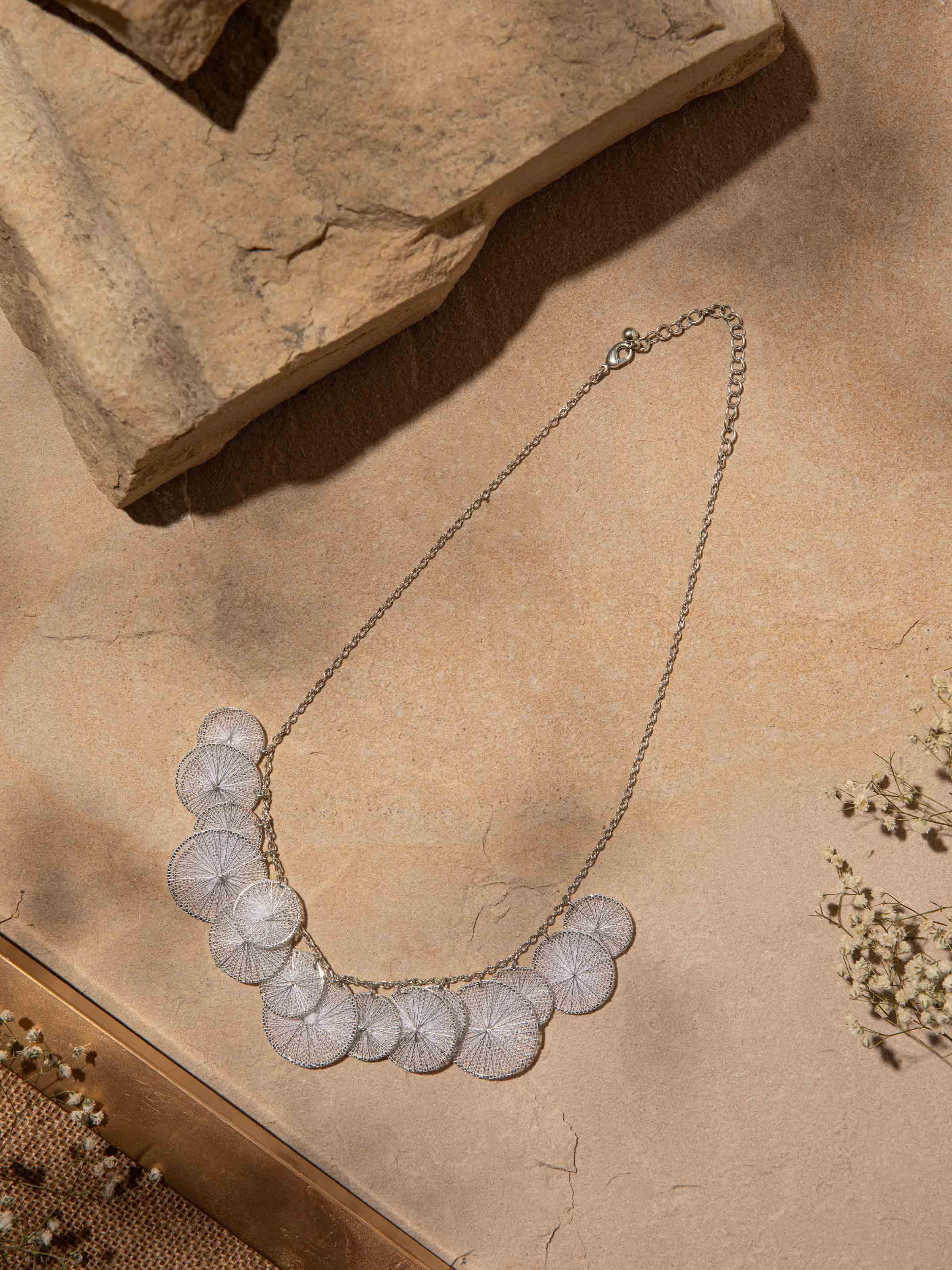 Angled view of String Craft Long Necklace showcasing the intricate string detailing and overall design.