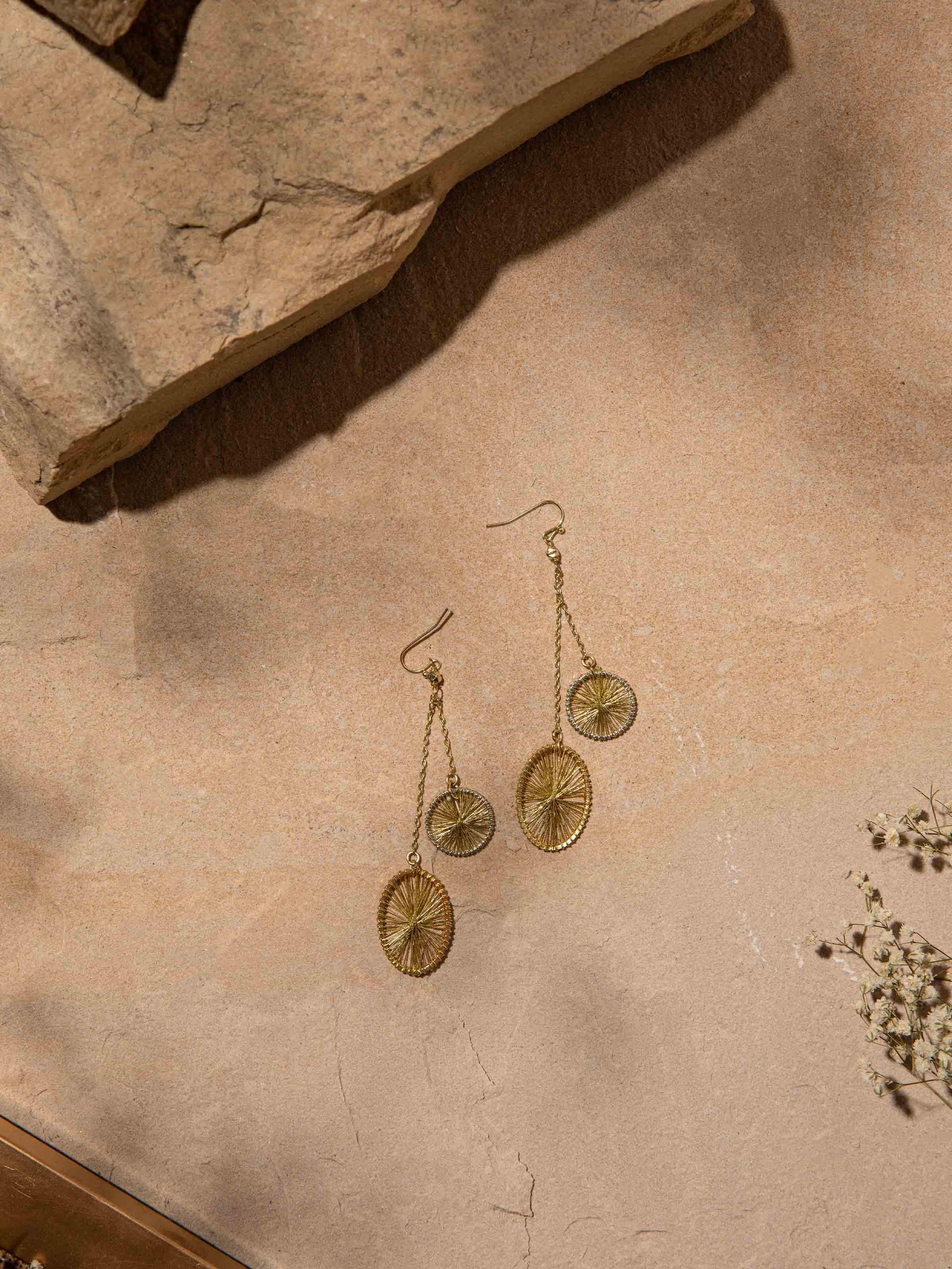 Angled view of String Craft Drop Earrings highlighting detailed string work and design.