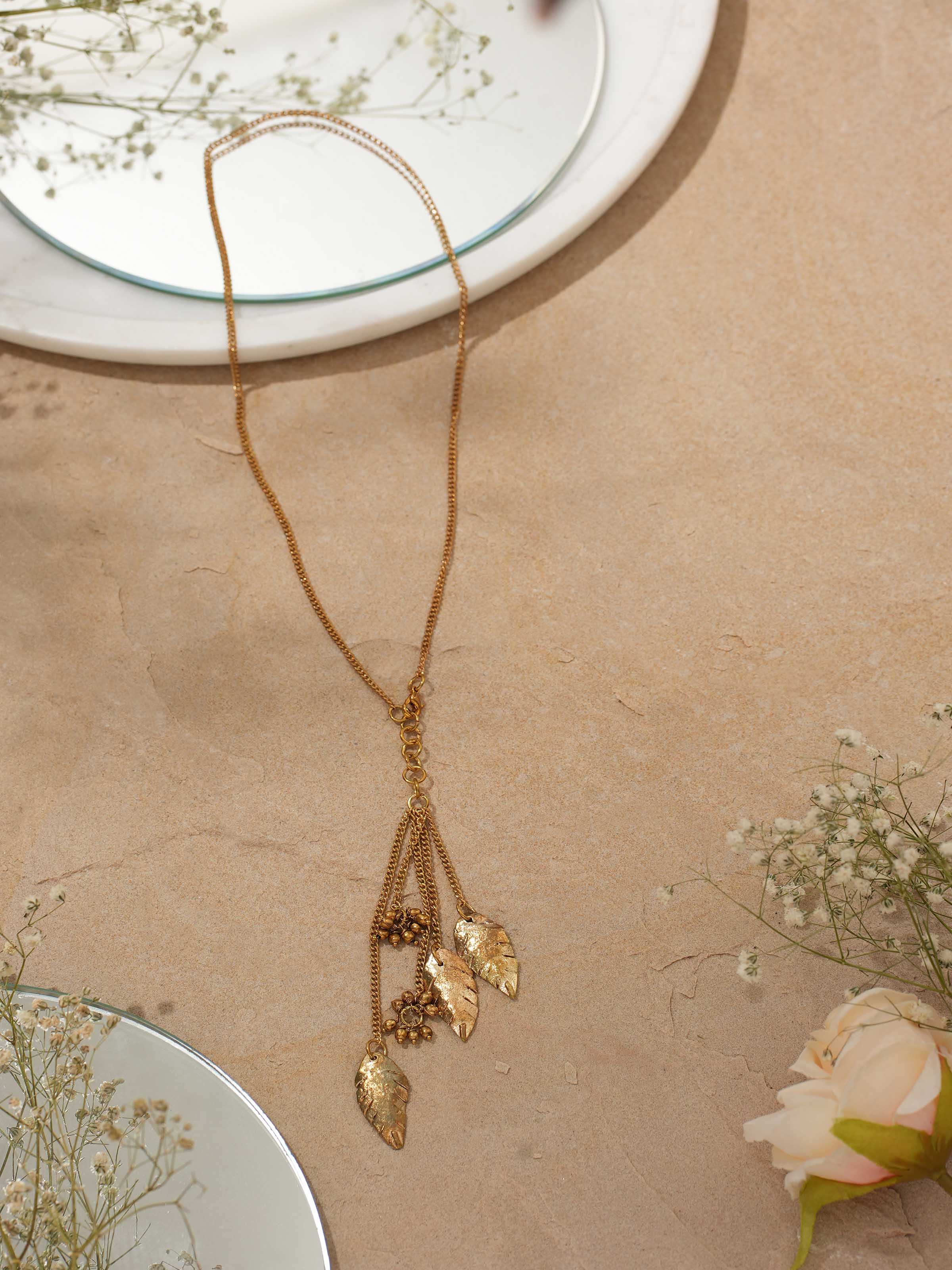 Side view of Dhokra Pendant & Chain showcasing the pendant's intricate design and elegant chain.