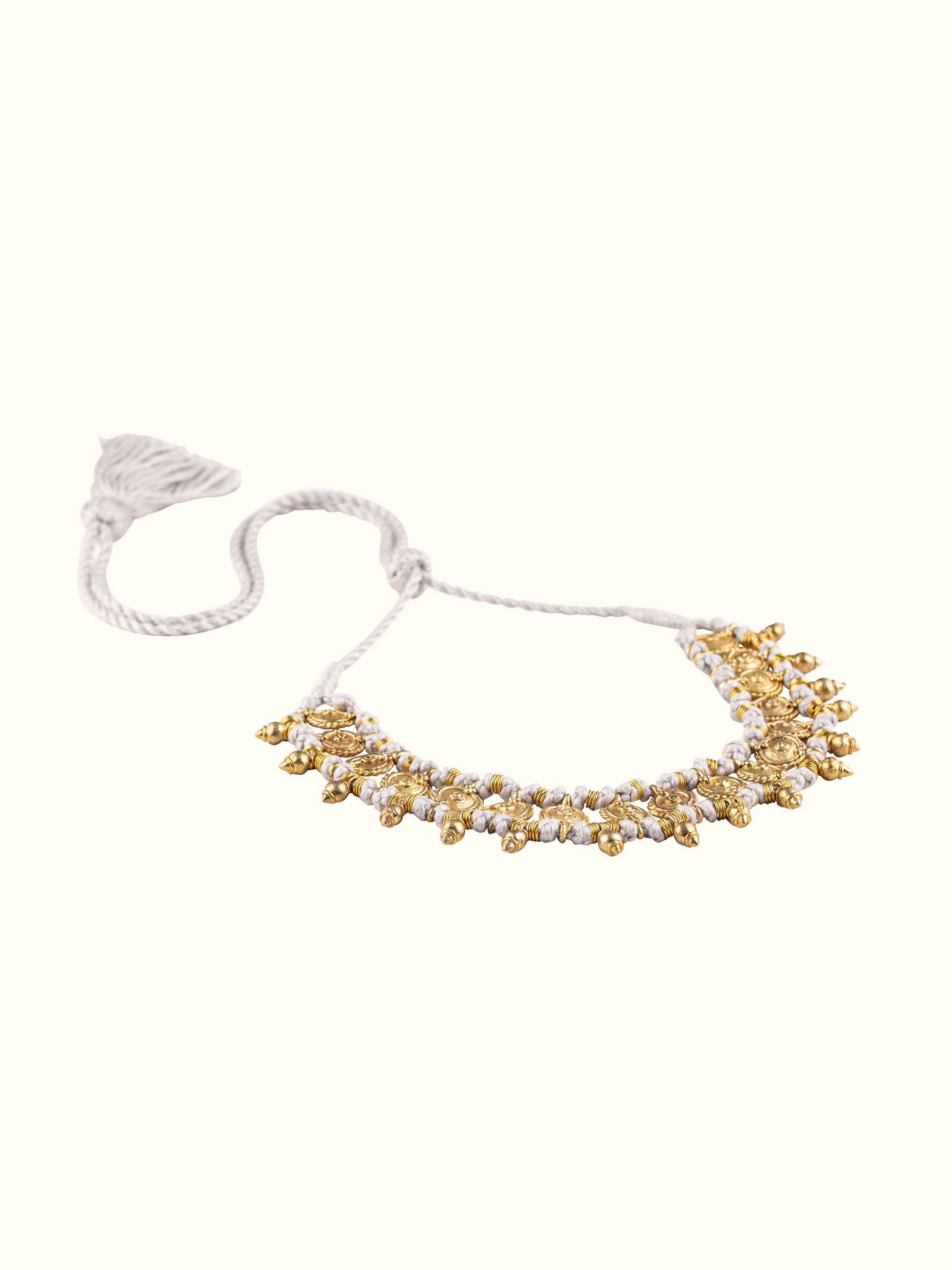 Angled view of Dhokra Choker showcasing its elaborate design and traditional metalwork.