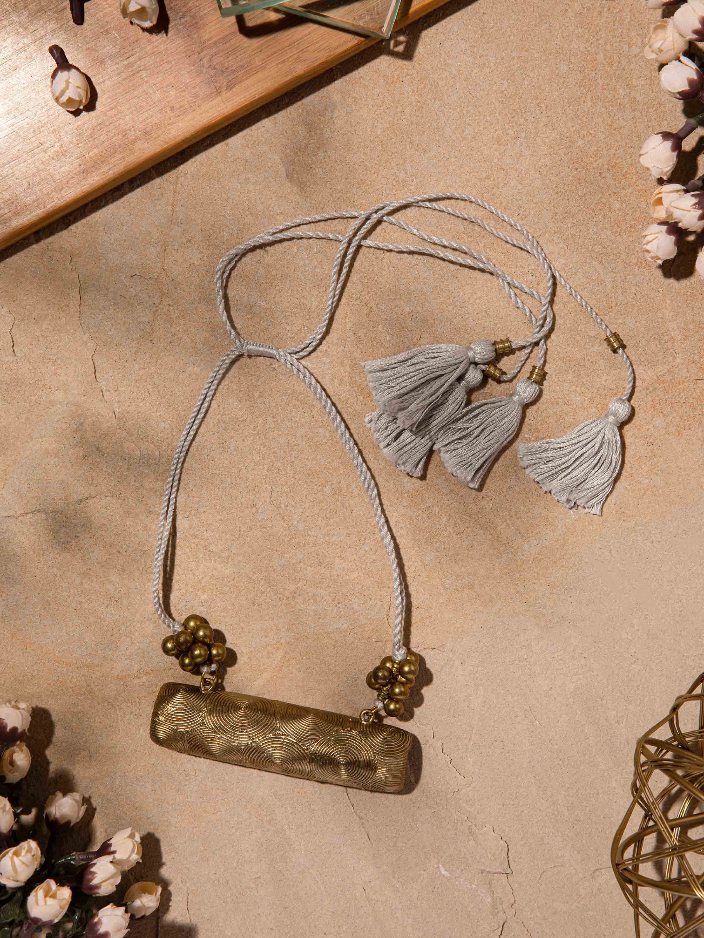 Close-up of Dhokra long necklace displaying traditional metal embellishments.