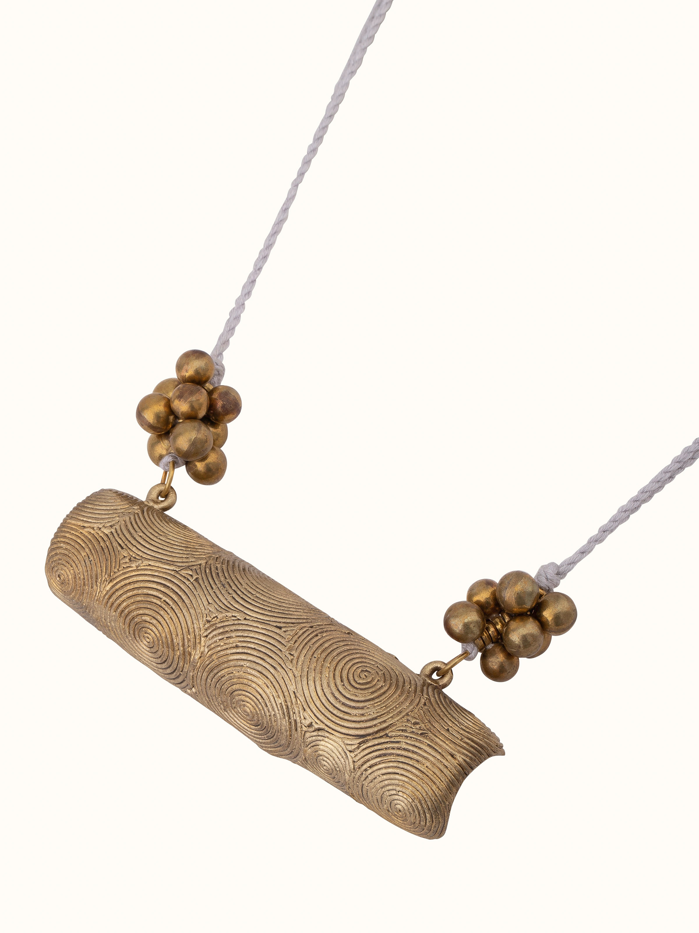 Angled view of Dhokra long necklace showing the artistic pendant design.