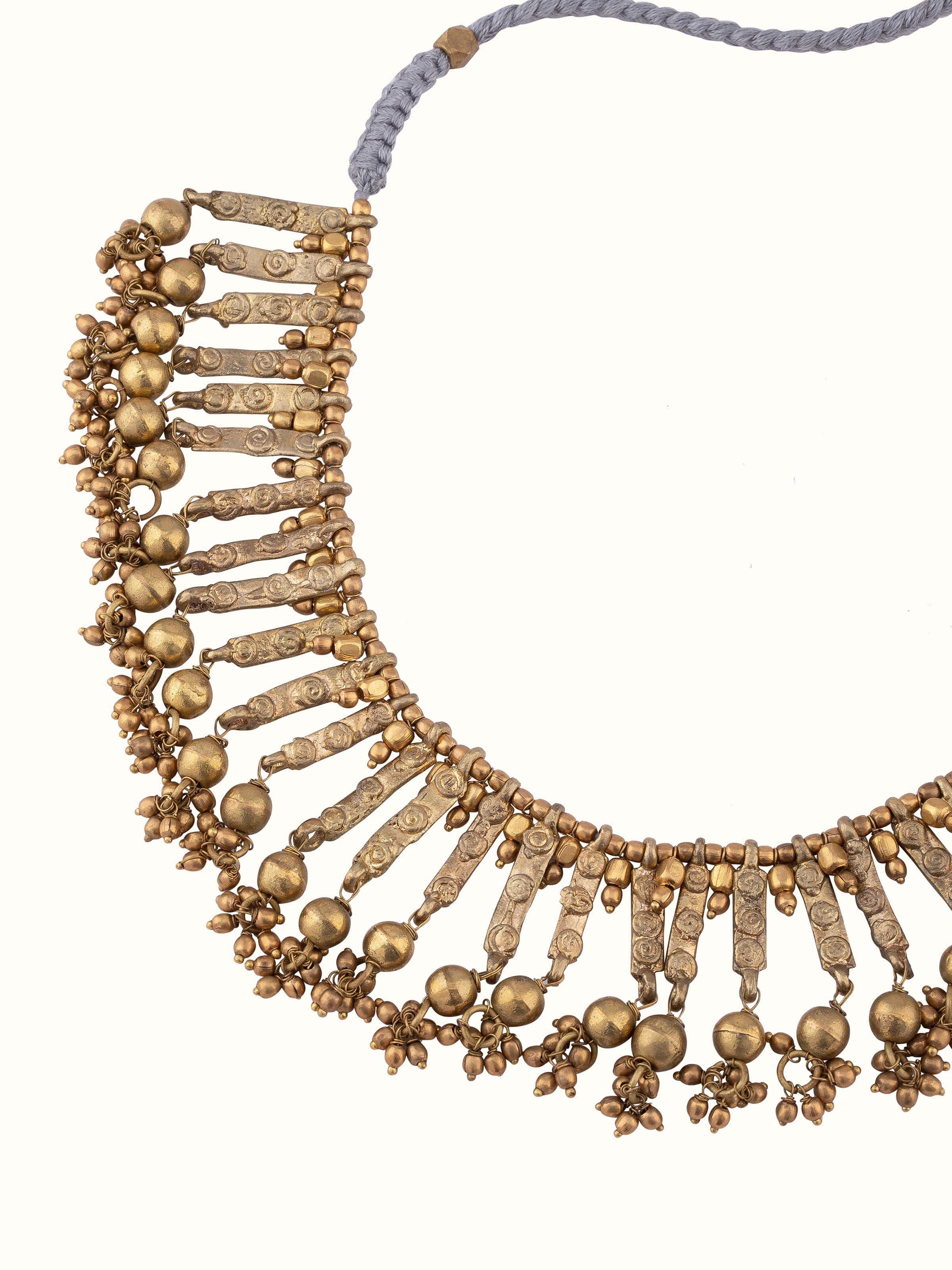 Overhead view of Dhokra choker showing its full design and elaborate metalwork.