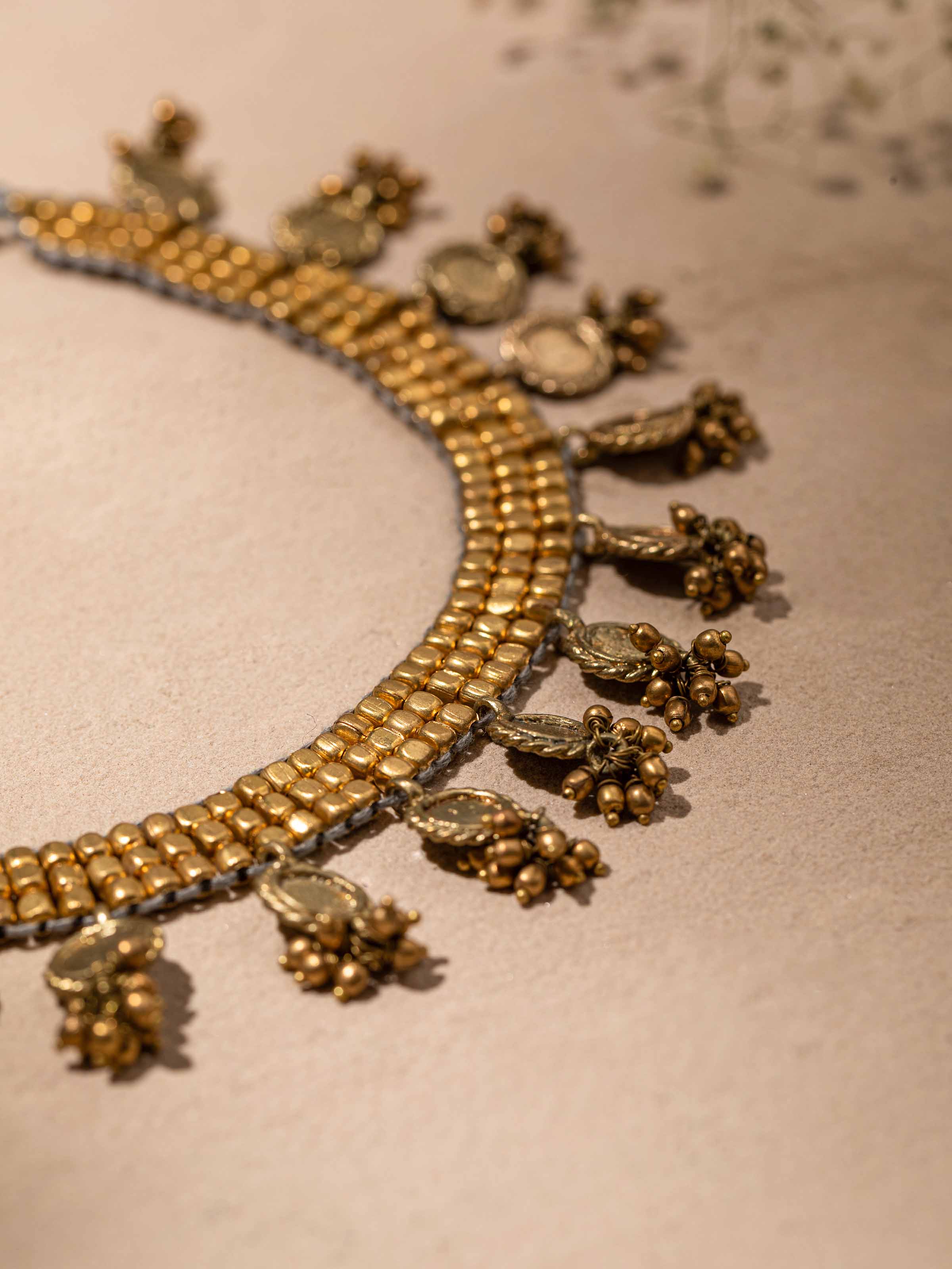 Detailed shot of Dhokra choker showing handcrafted metal elements and ornate design