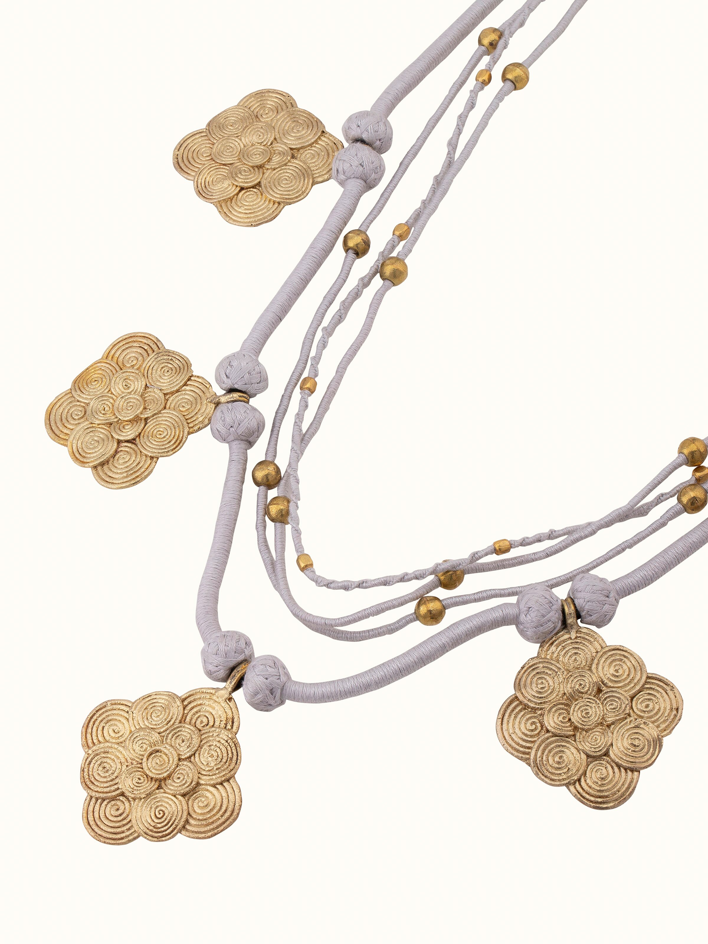 Angled view of Dhokra Long Necklace showcasing its traditional design and intricate metal detailing.