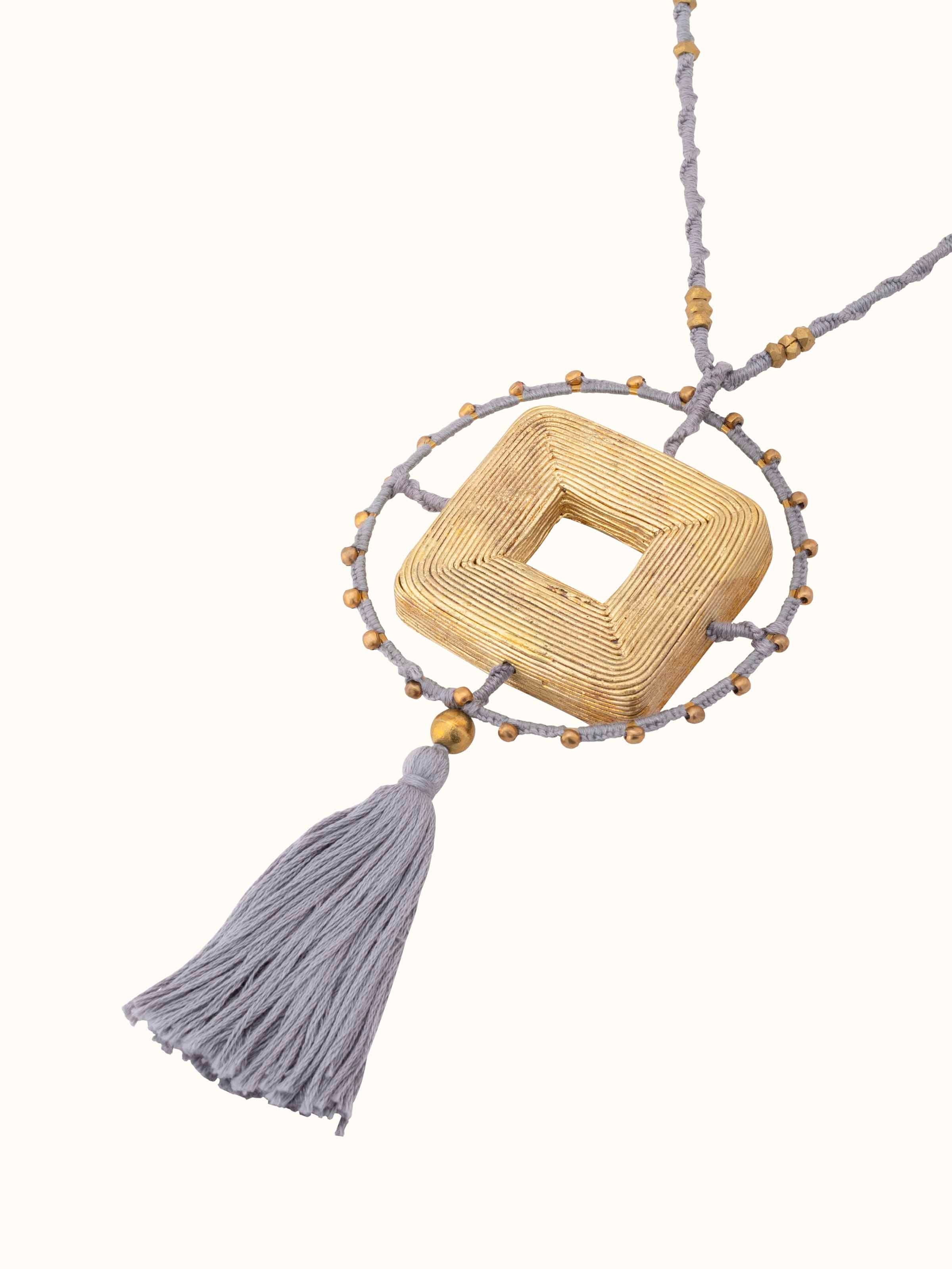Angled view of Dhokra Pendant & Chain showcasing the detailed artistry and chain design.