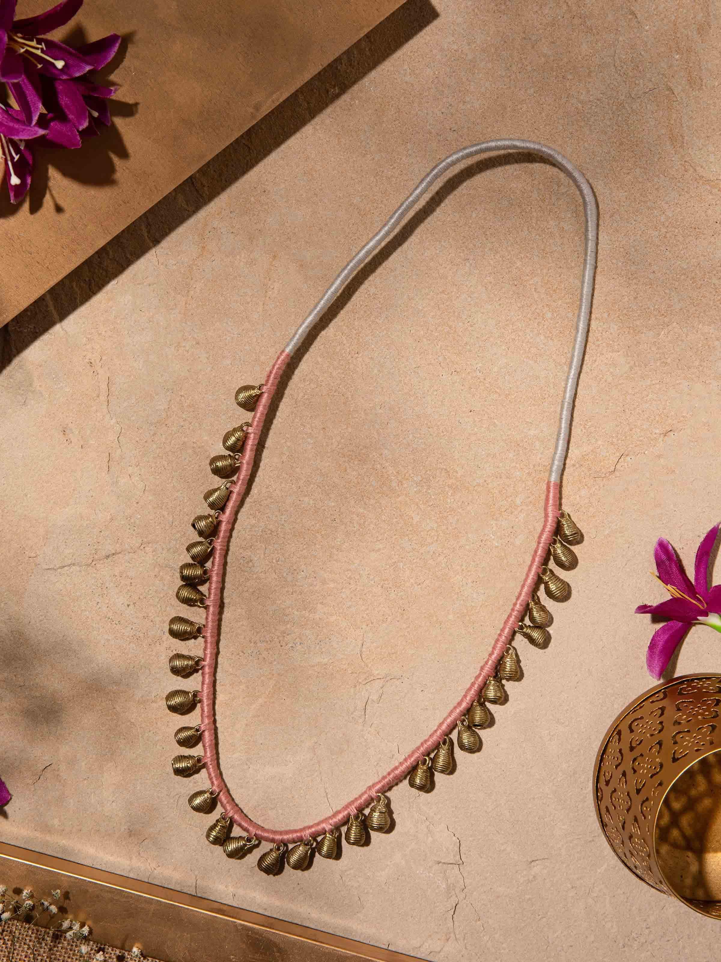 Close-up of Dhokra long necklace focusing on the detailed metalwork and traditional design.
