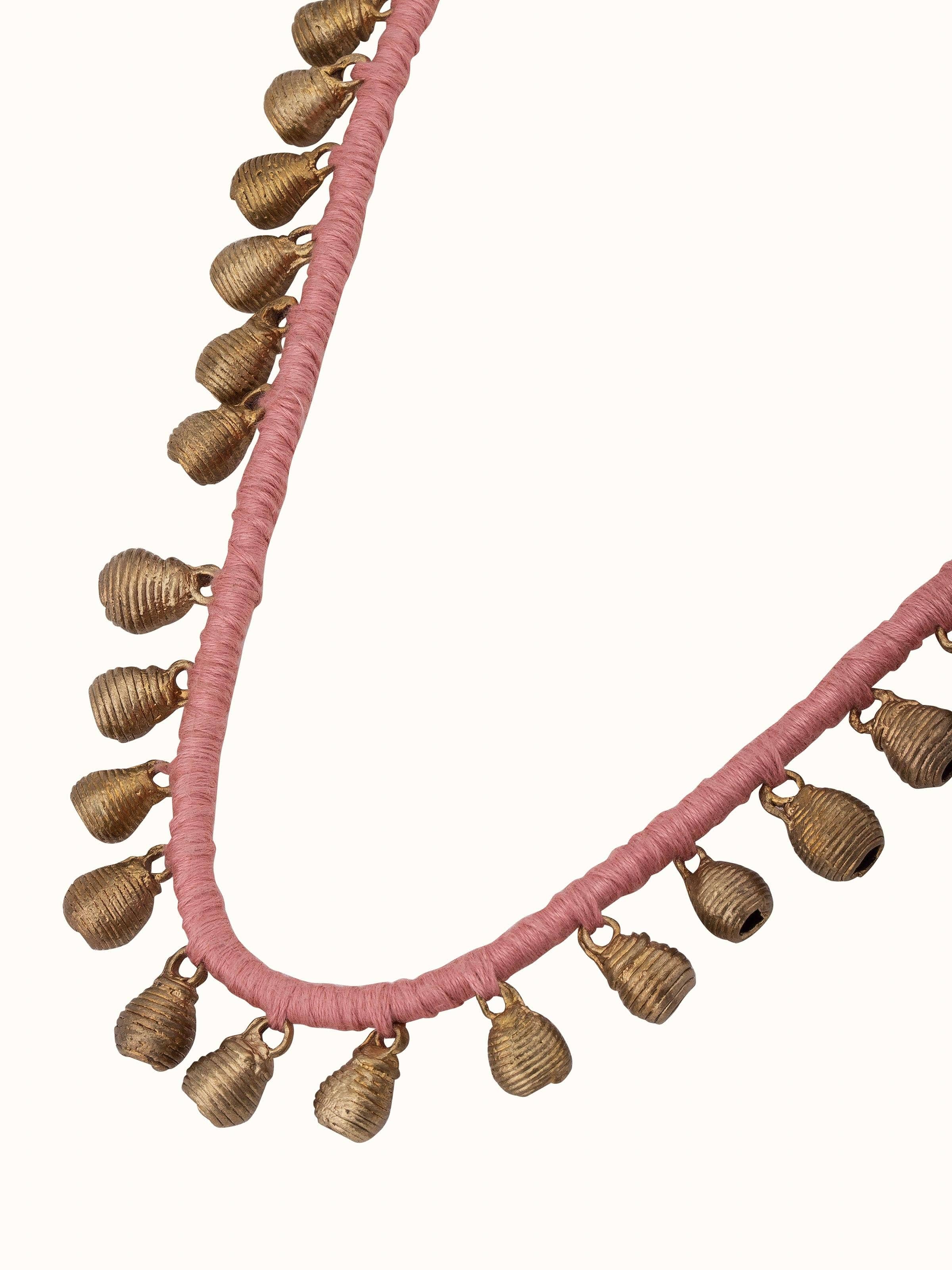 Dhokra long necklace displayed on a flat surface highlighting its elegant design and traditional craftsmanship.