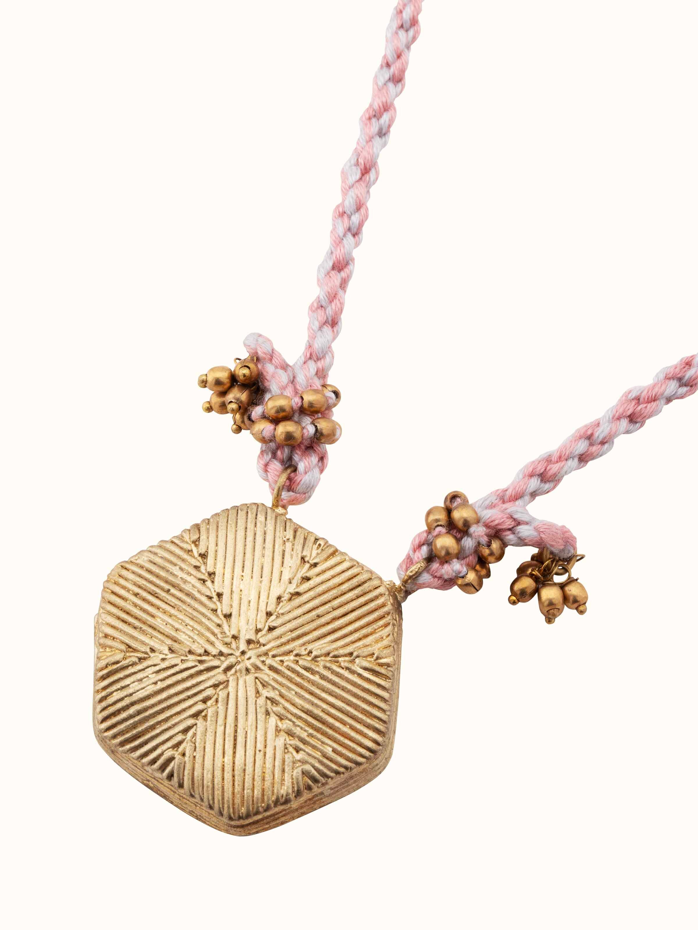 Detailed view of Dhokra pendant and chain emphasizing intricate design elements.