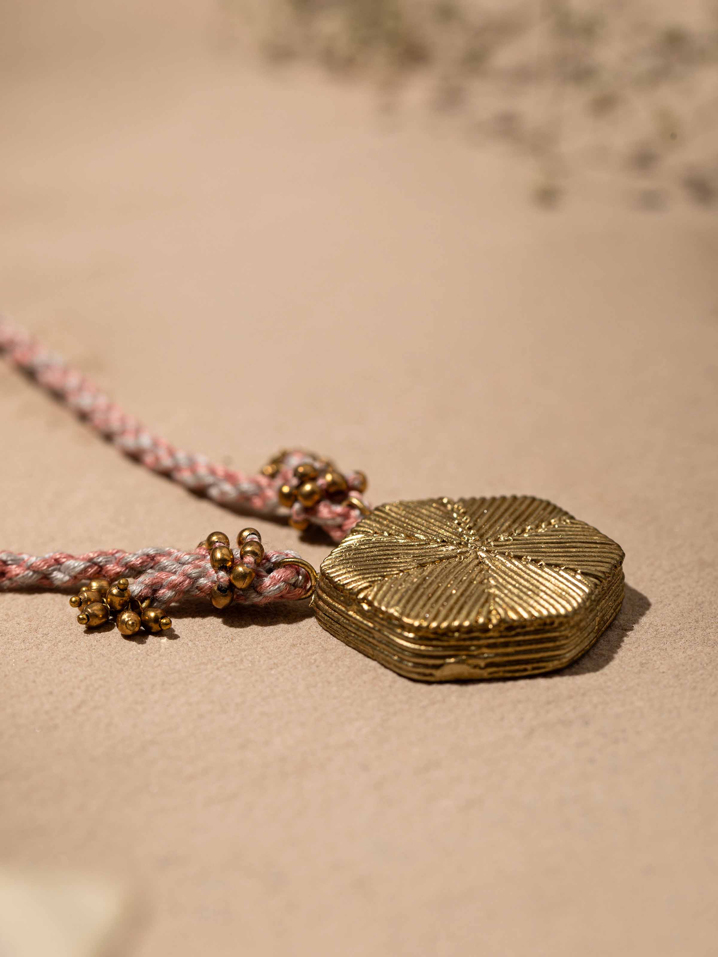 Back view of Dhokra pendant and chain showcasing secure clasp and overall design.