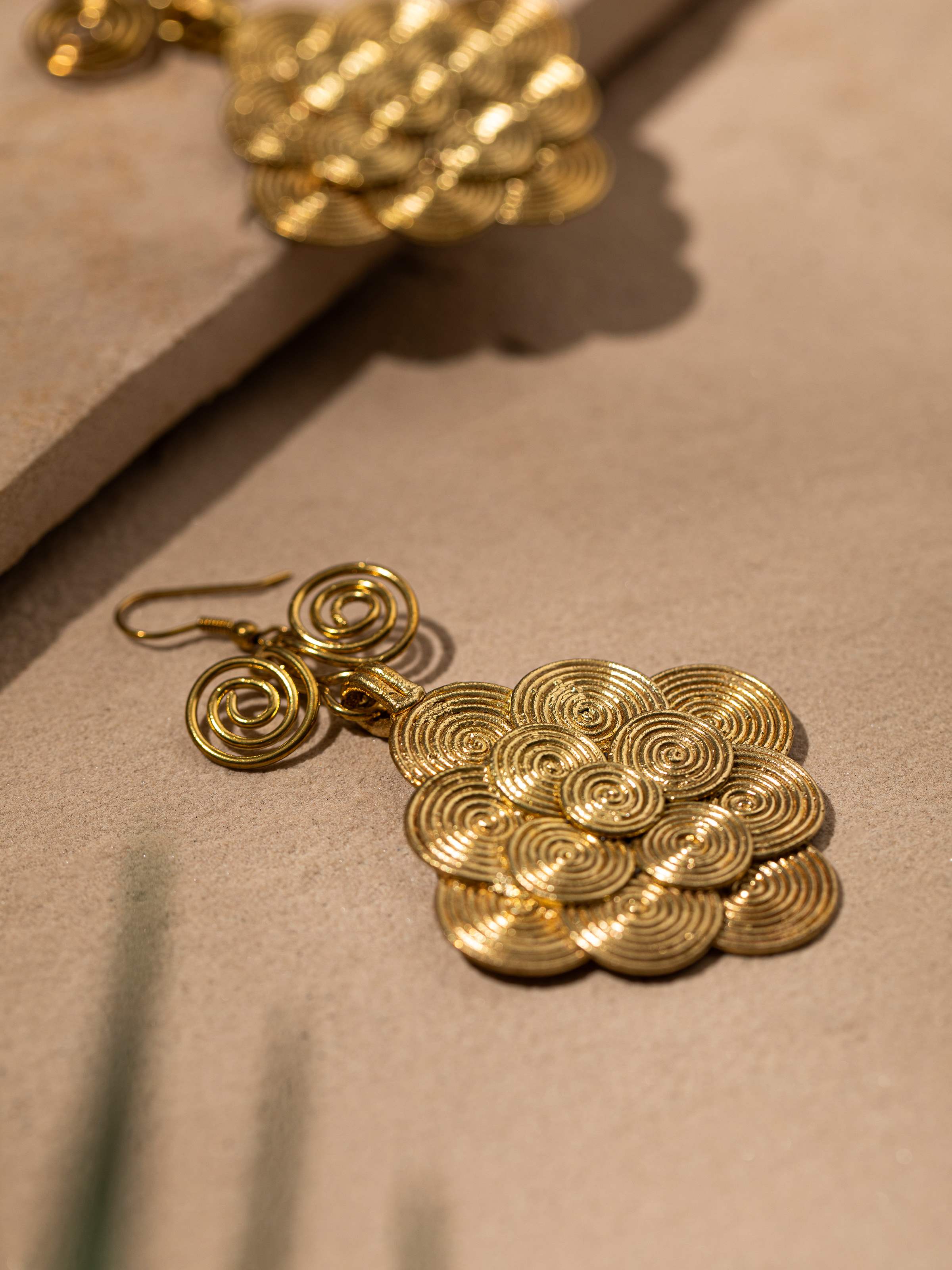 Detailed view of Dhokra Drop Earrings from a distance showcasing their intricate design and finish.
