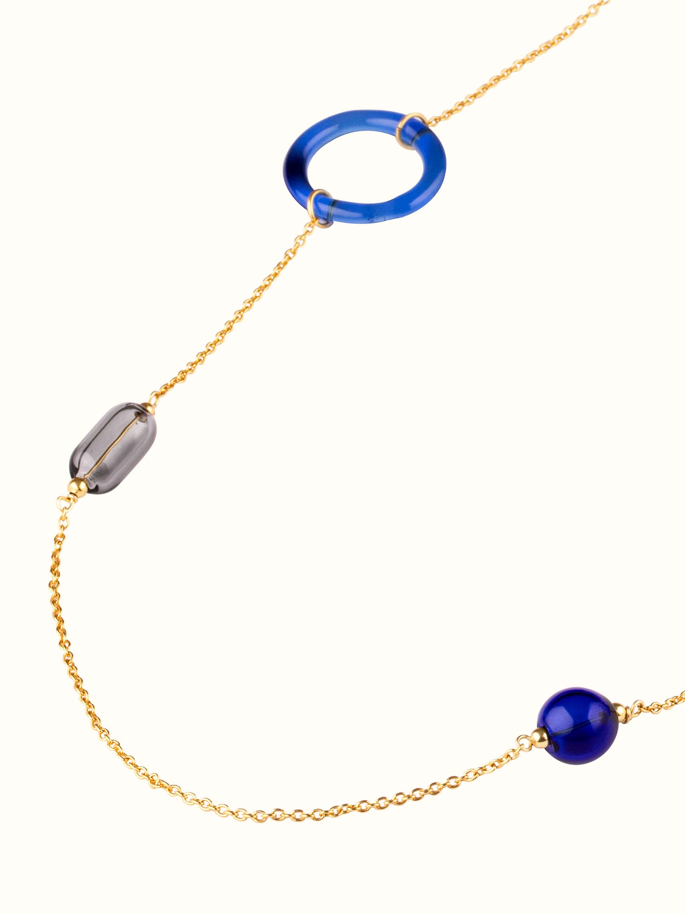 Angled view of Silver Flame Glass Long Necklace to emphasize its unique design and glass details.