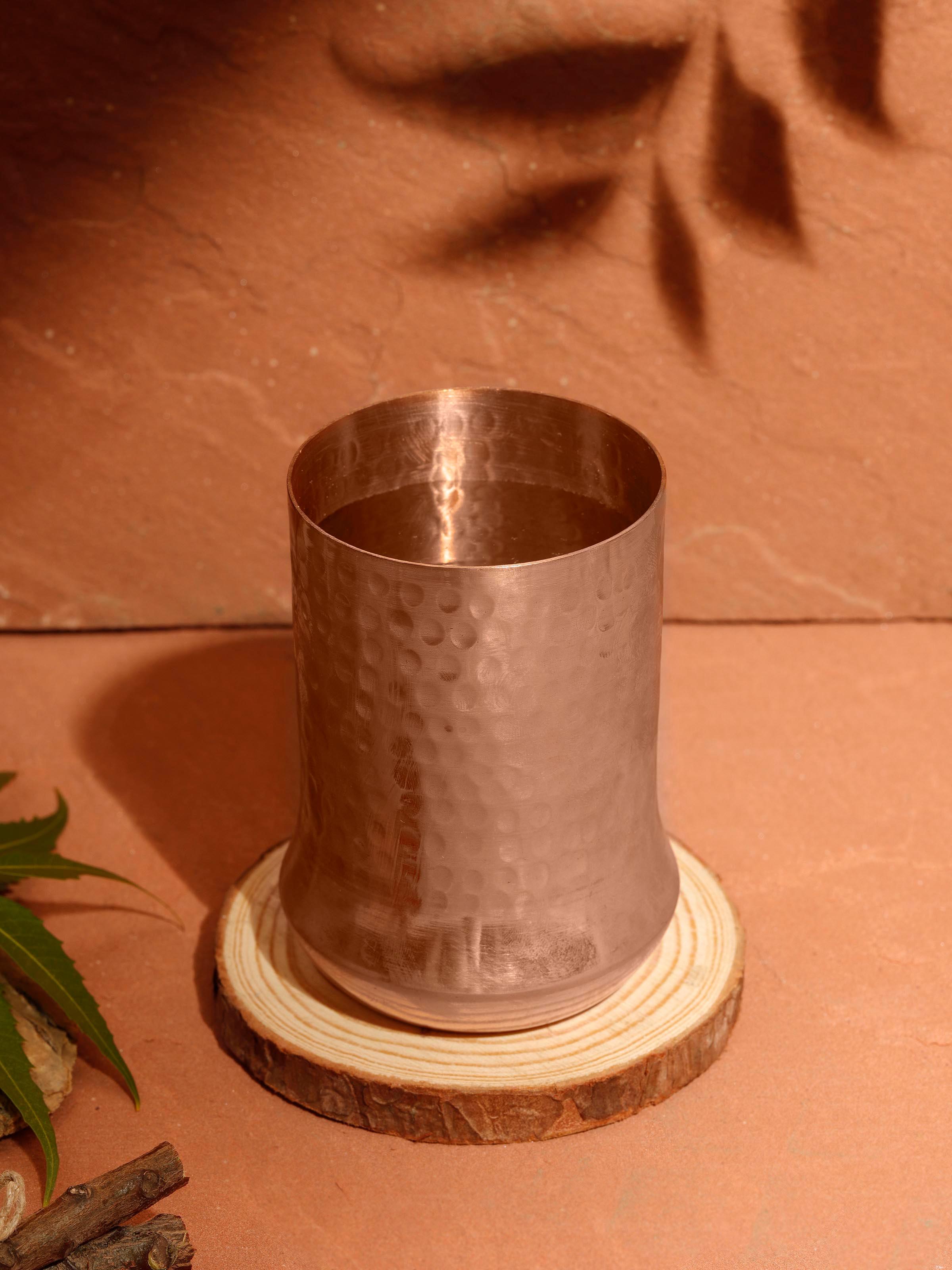 Side view of refined copper metal glass showcasing smooth, shiny surface.
