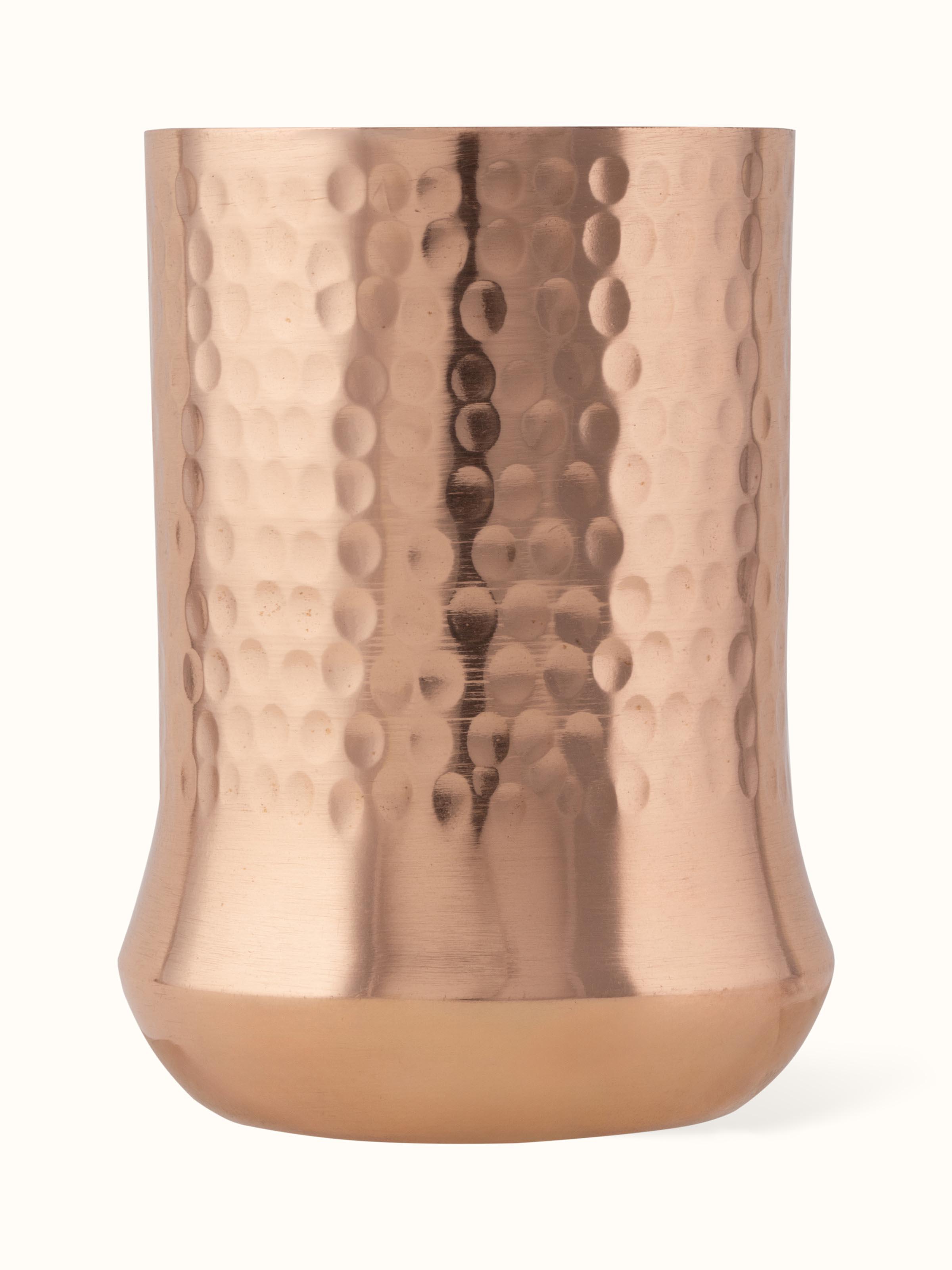 Angled view of copper metal glass emphasizing its elegant shape and design.