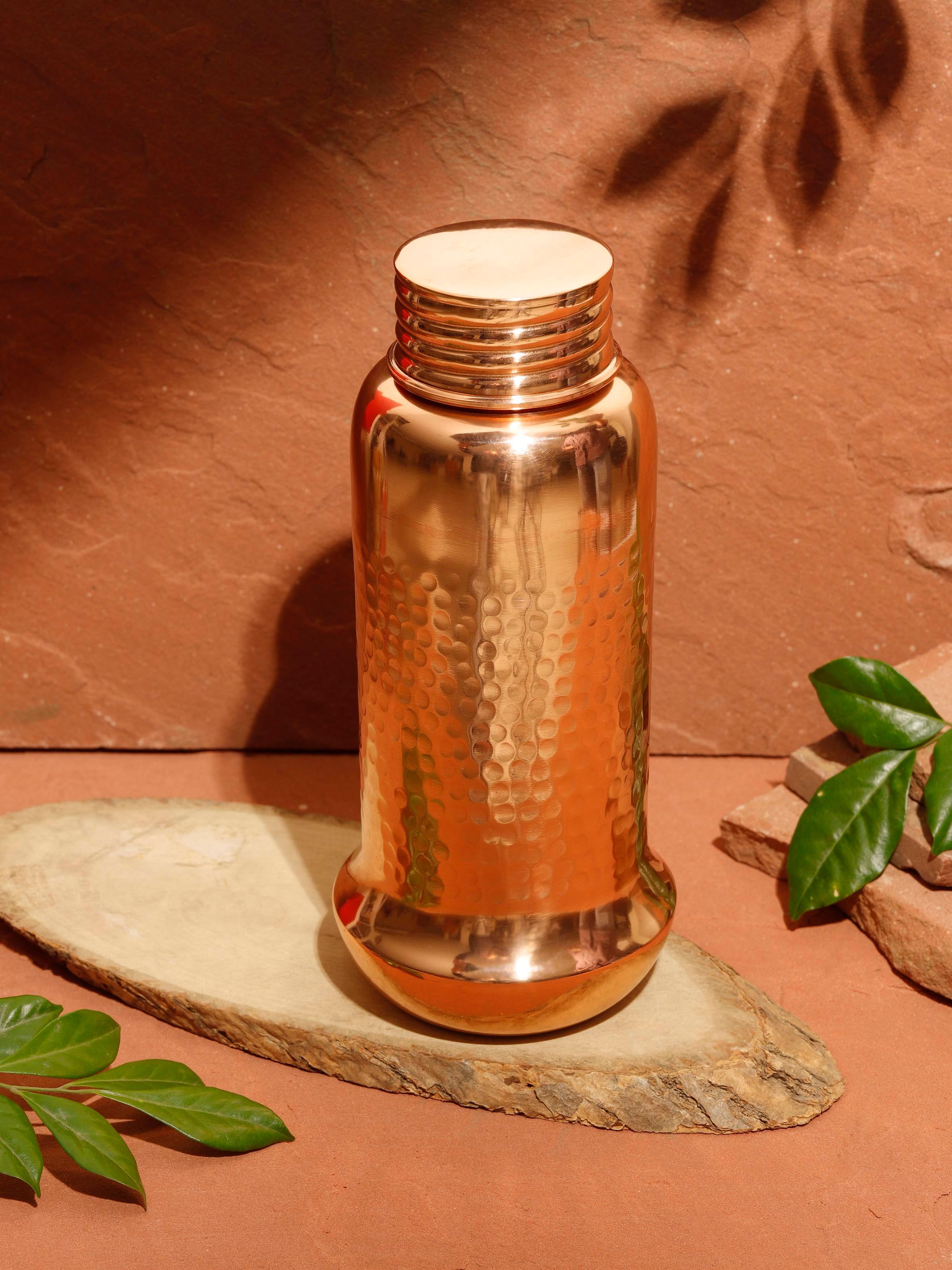 Side view of Copper Metal Hammered Bottle highlighting the detailed hammered finish and bottle shape.