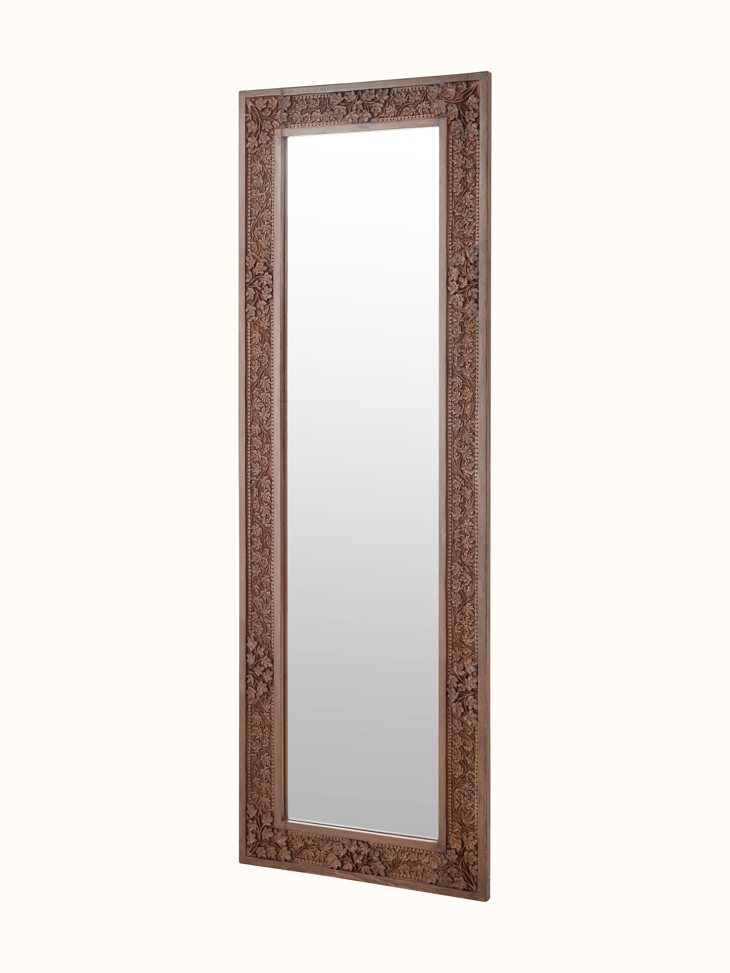Close-up of the carved walnut wood frame and glass surface of the full-length mirror, highlighting intricate details.