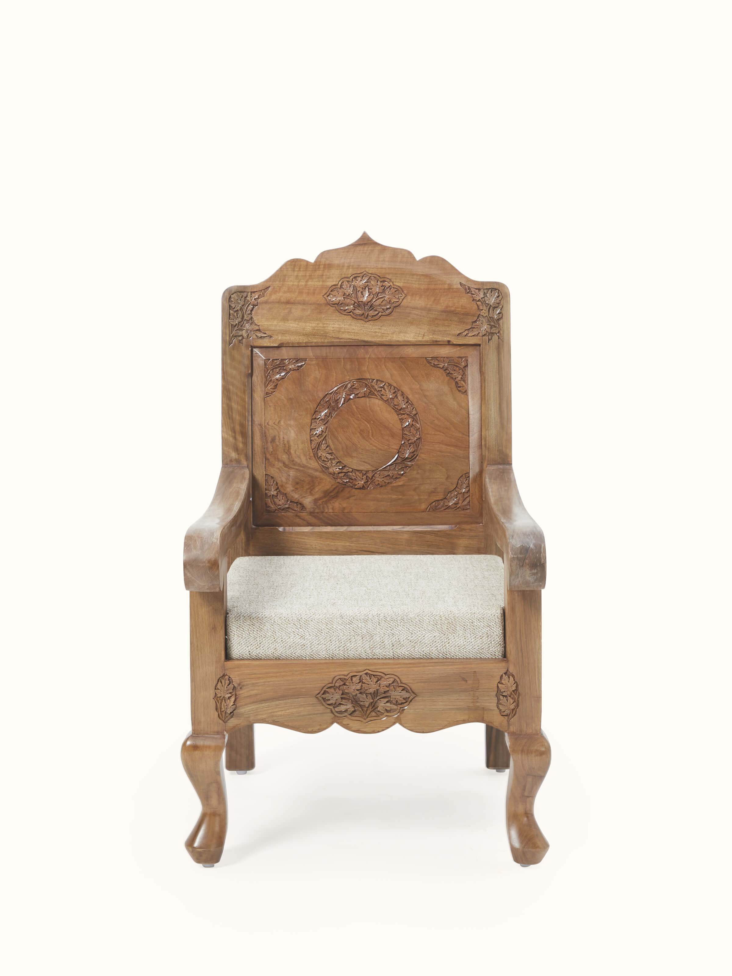 Front view of the handloom fabric upholstered carved walnut wood armchair, showcasing its elegant design and detailed wood carving