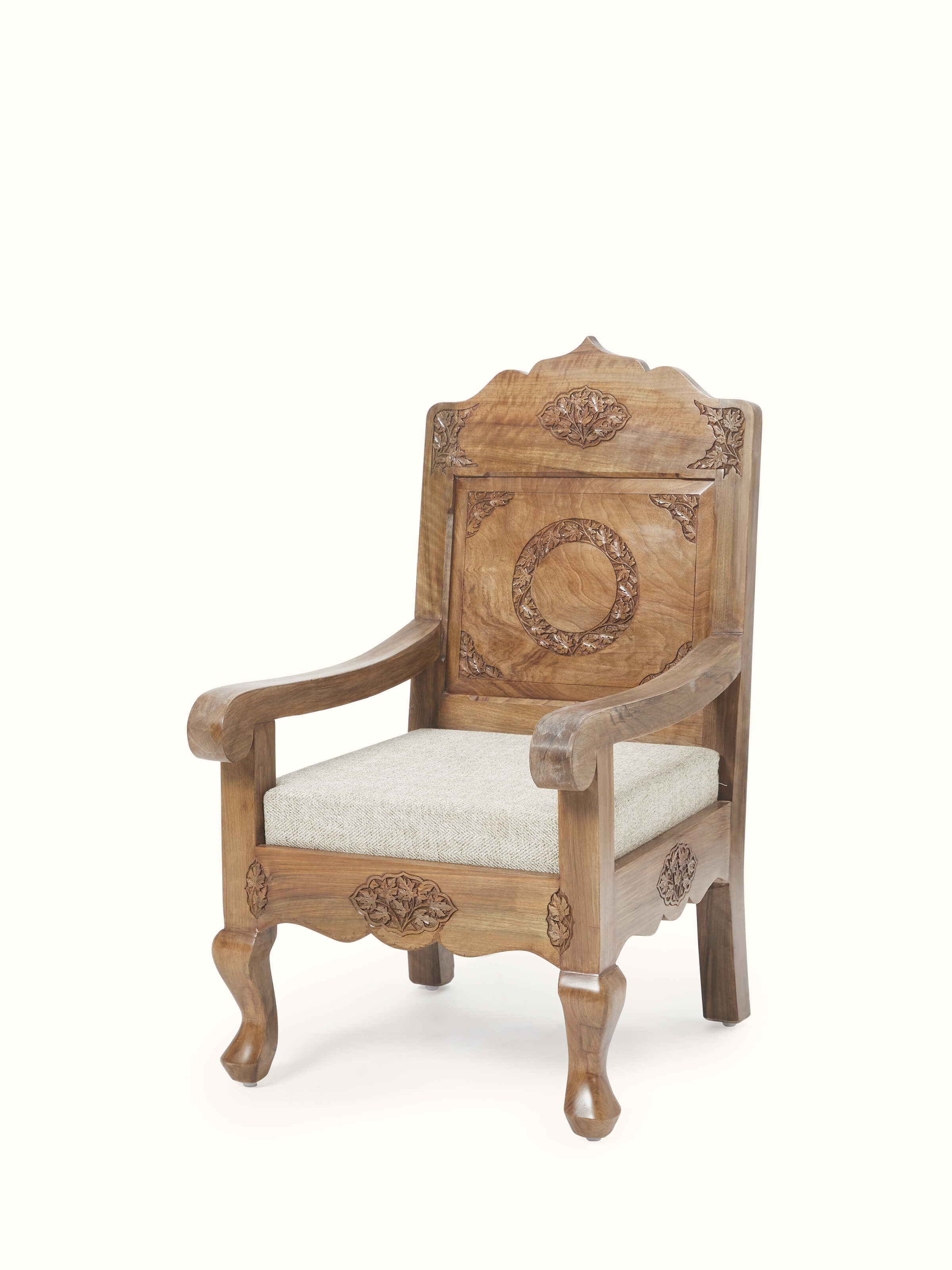 Side view of the handloom fabric upholstered carved walnut wood armchair, highlighting the craftsmanship and upholstered fabric