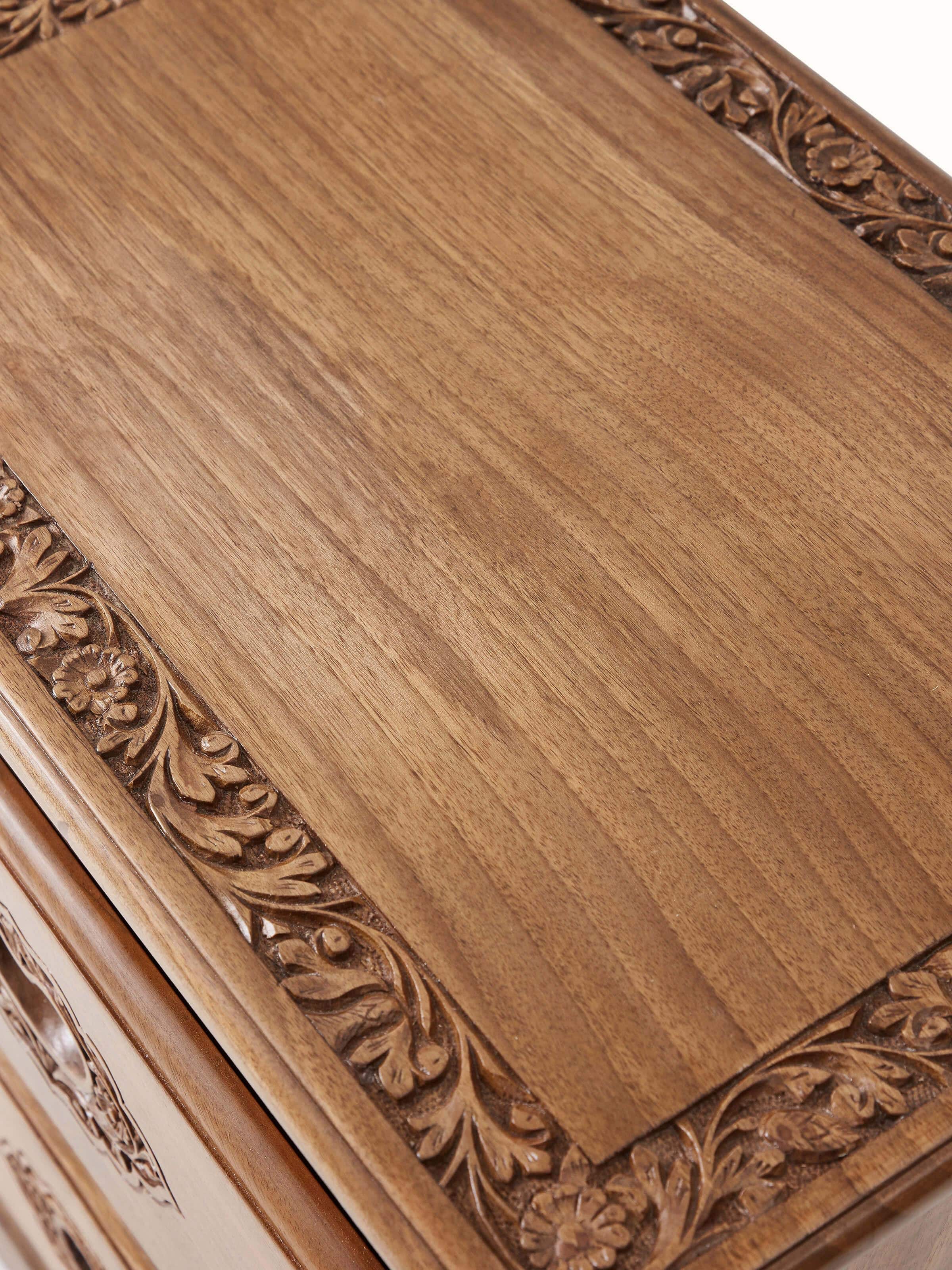 Angled view of the carved walnut wood bedside table, showing its structure and design from a different perspective
