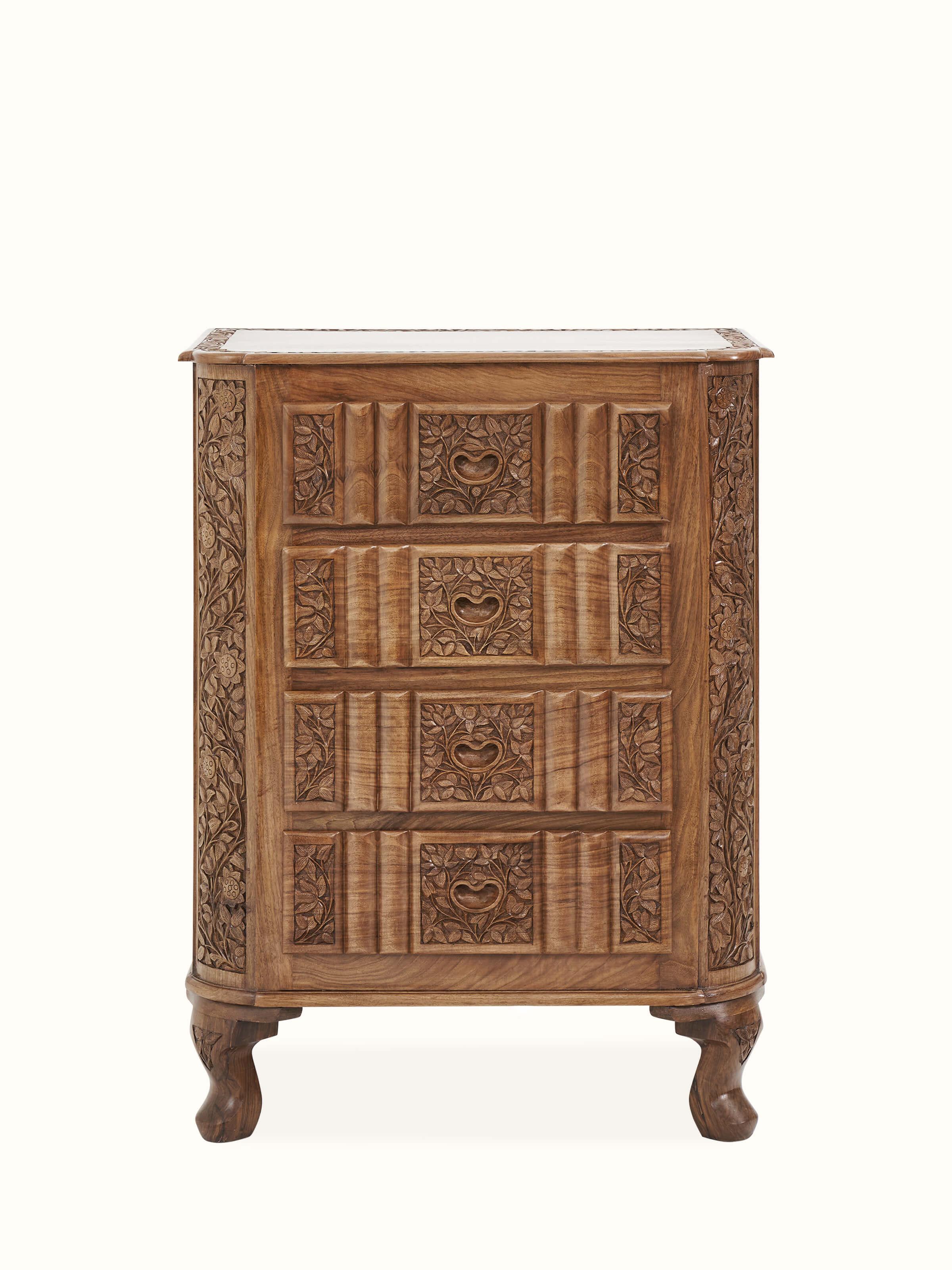 Front view of carved walnut drawer chest, showcasing intricate carving details