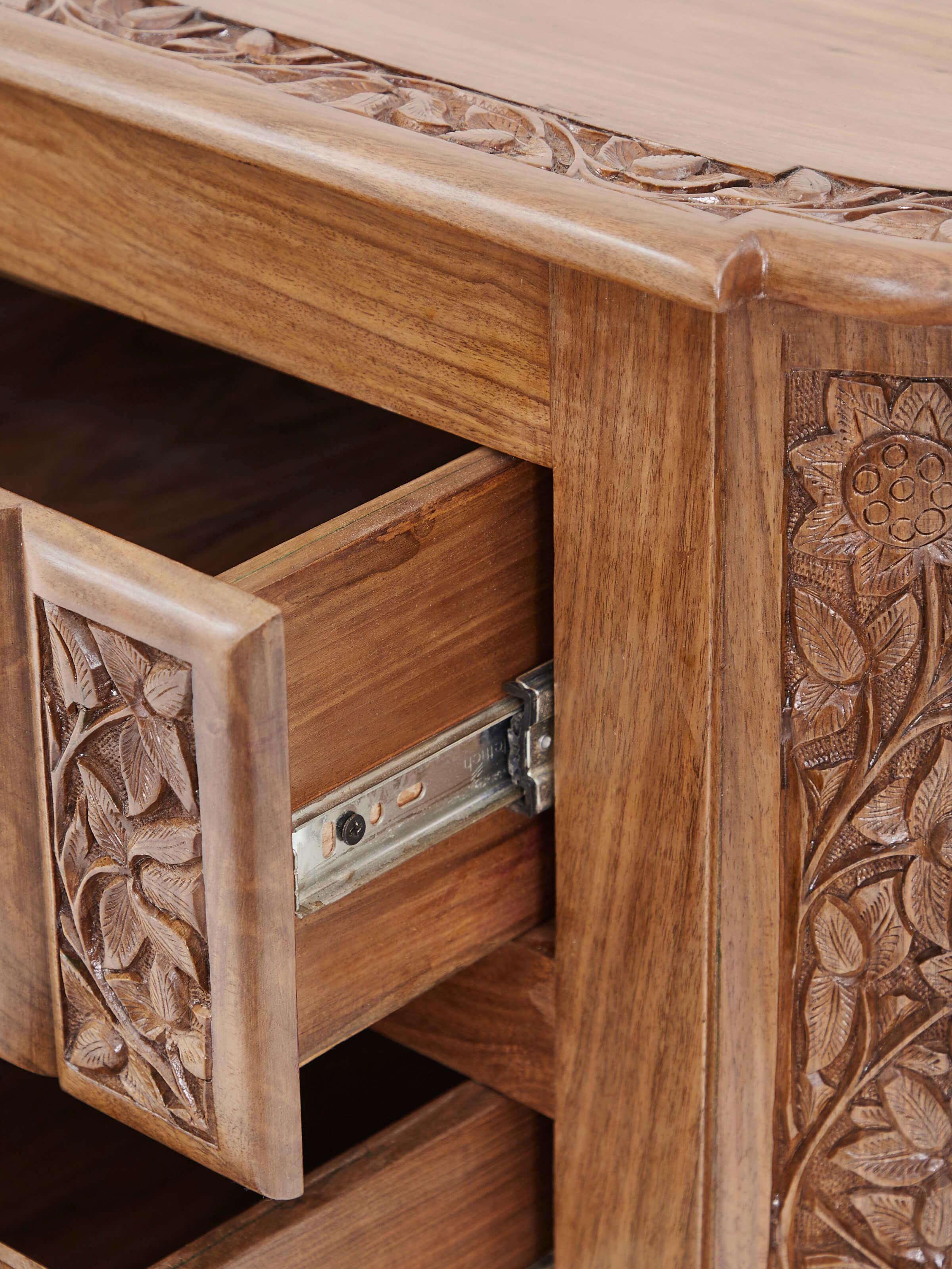 Top view of carved walnut drawer chest, highlighting the smooth finish and detailed craftsmanship