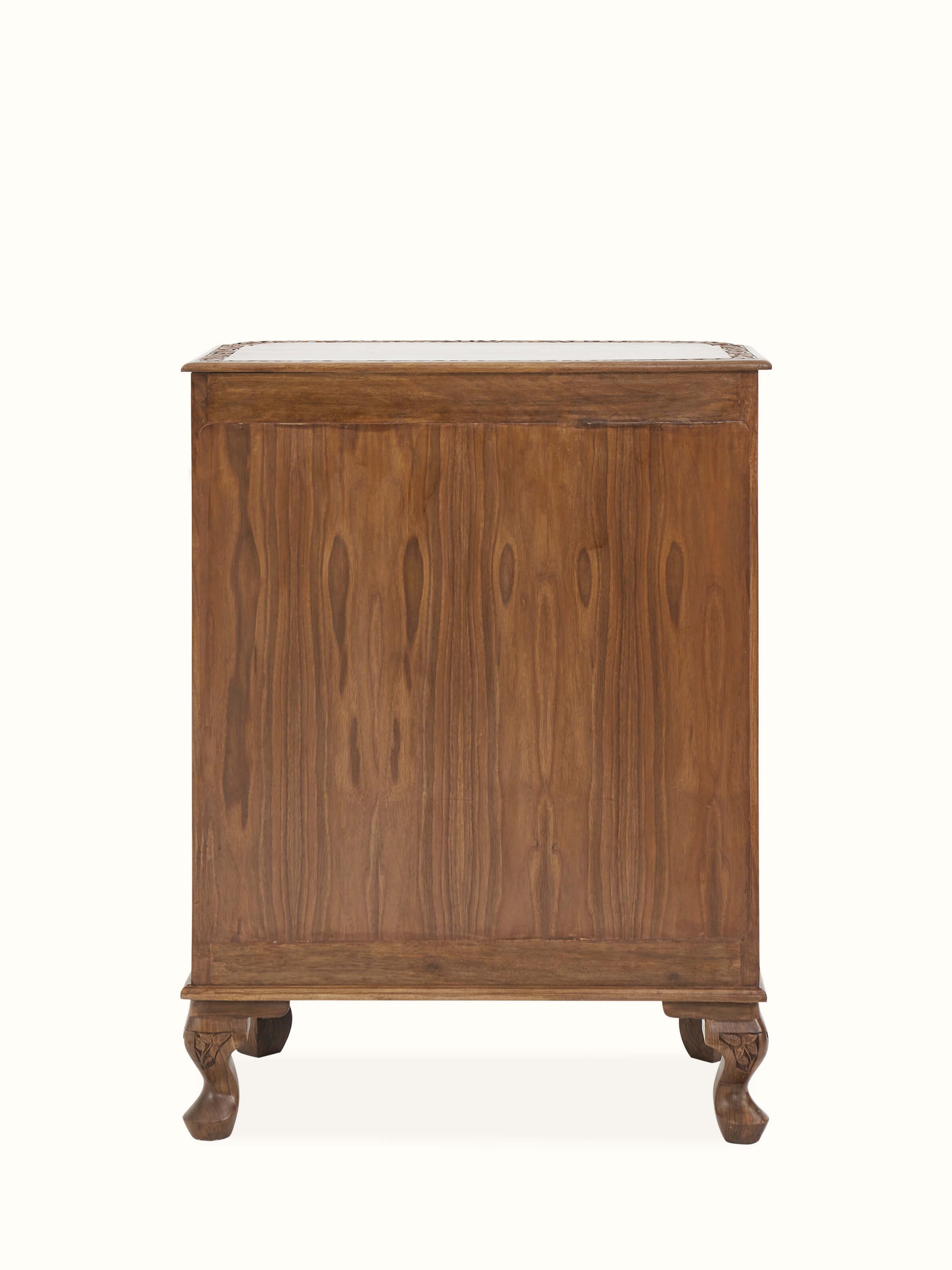 Back view of carved walnut drawer chest, showing the seamless wood finish