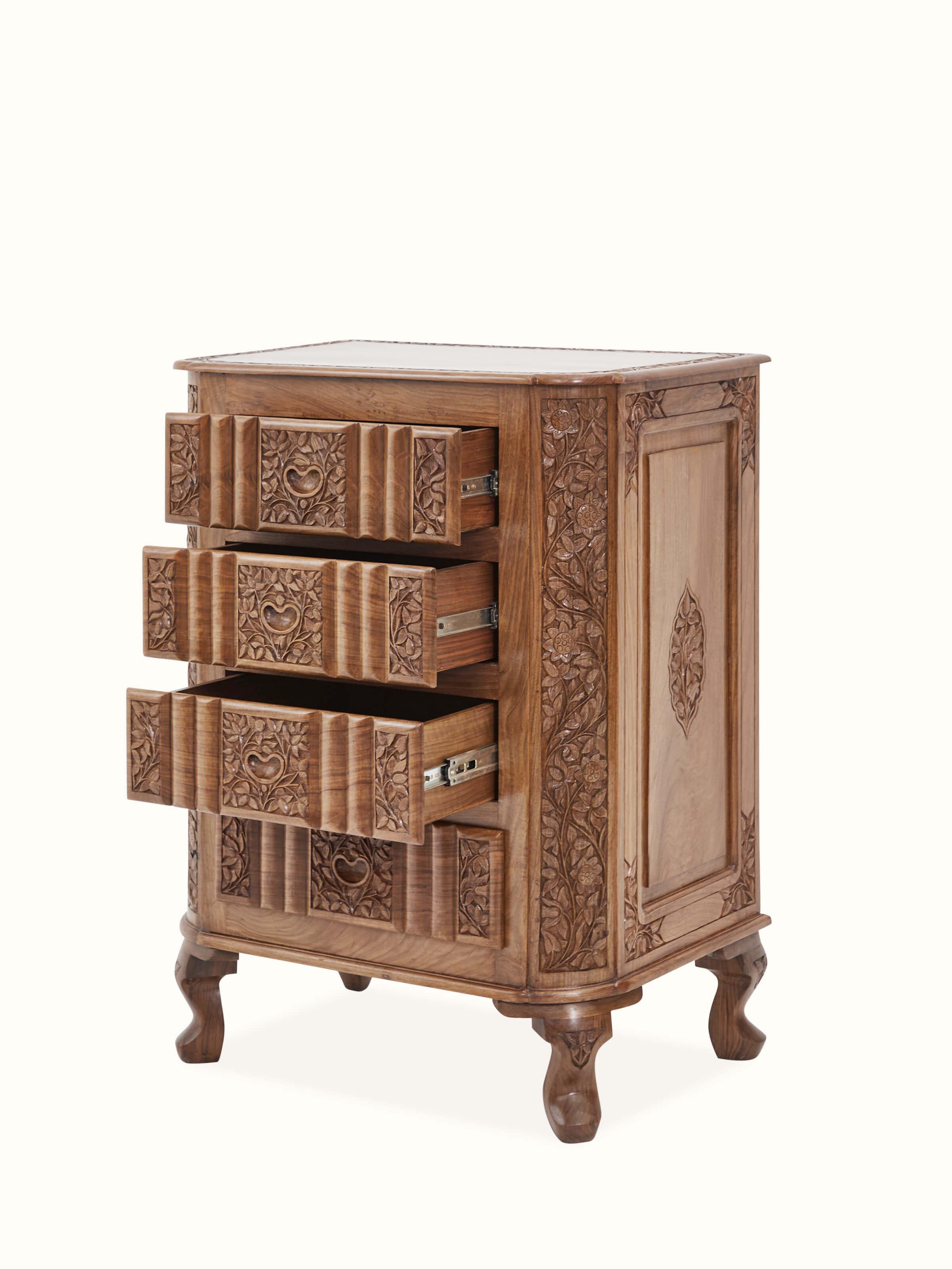 Overhead view of carved walnut drawer chest, emphasizing the detailed surface design