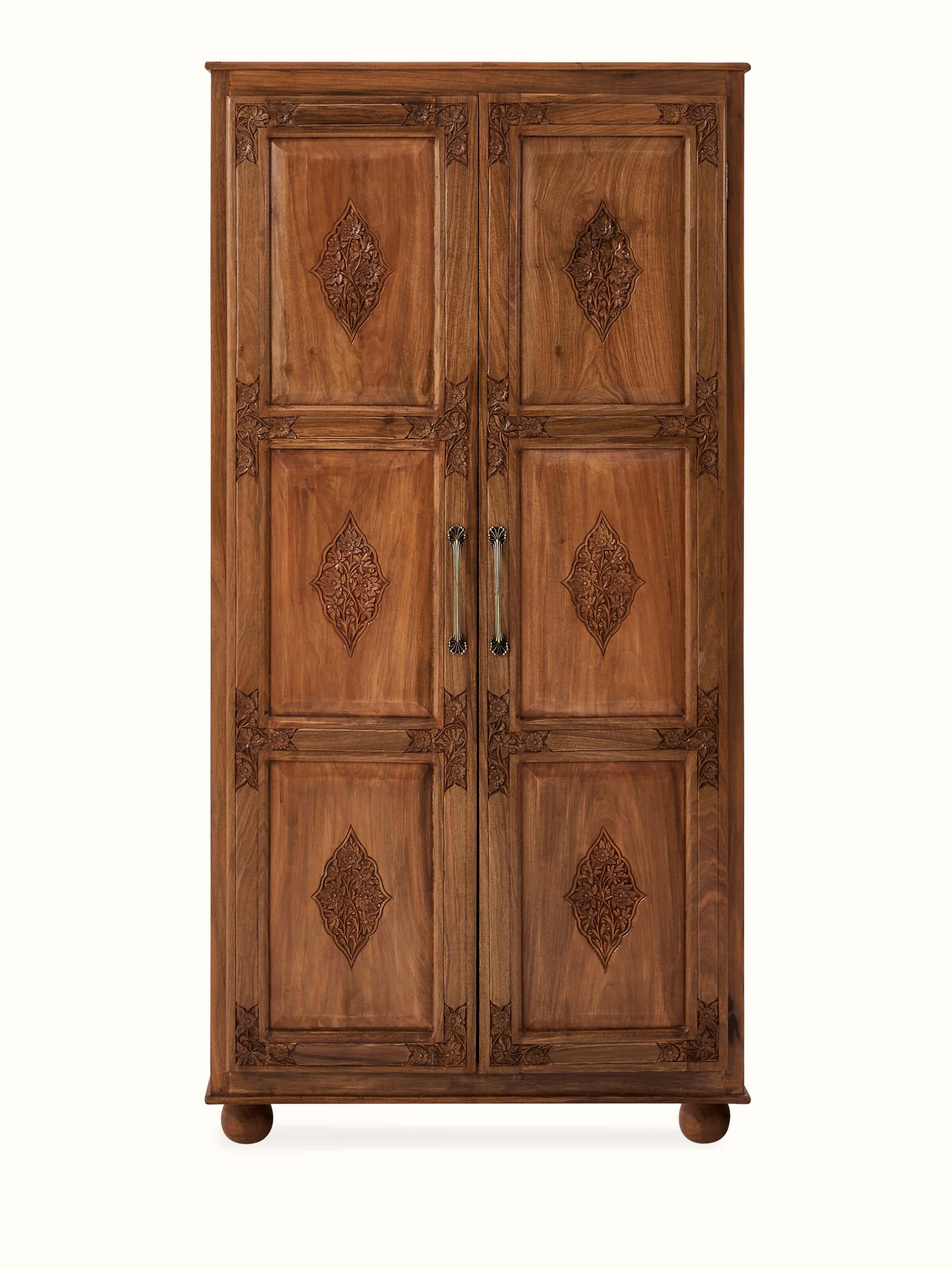 Front view of carved walnut wood wardrobe, showcasing intricate carvings and rich wood finish