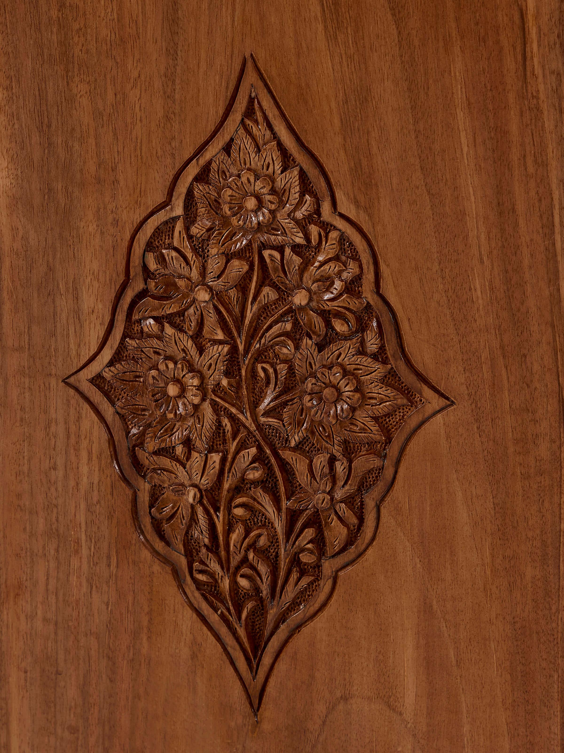 Perspective view of carved walnut wood wardrobe, emphasizing the depth and details of the wood carvings