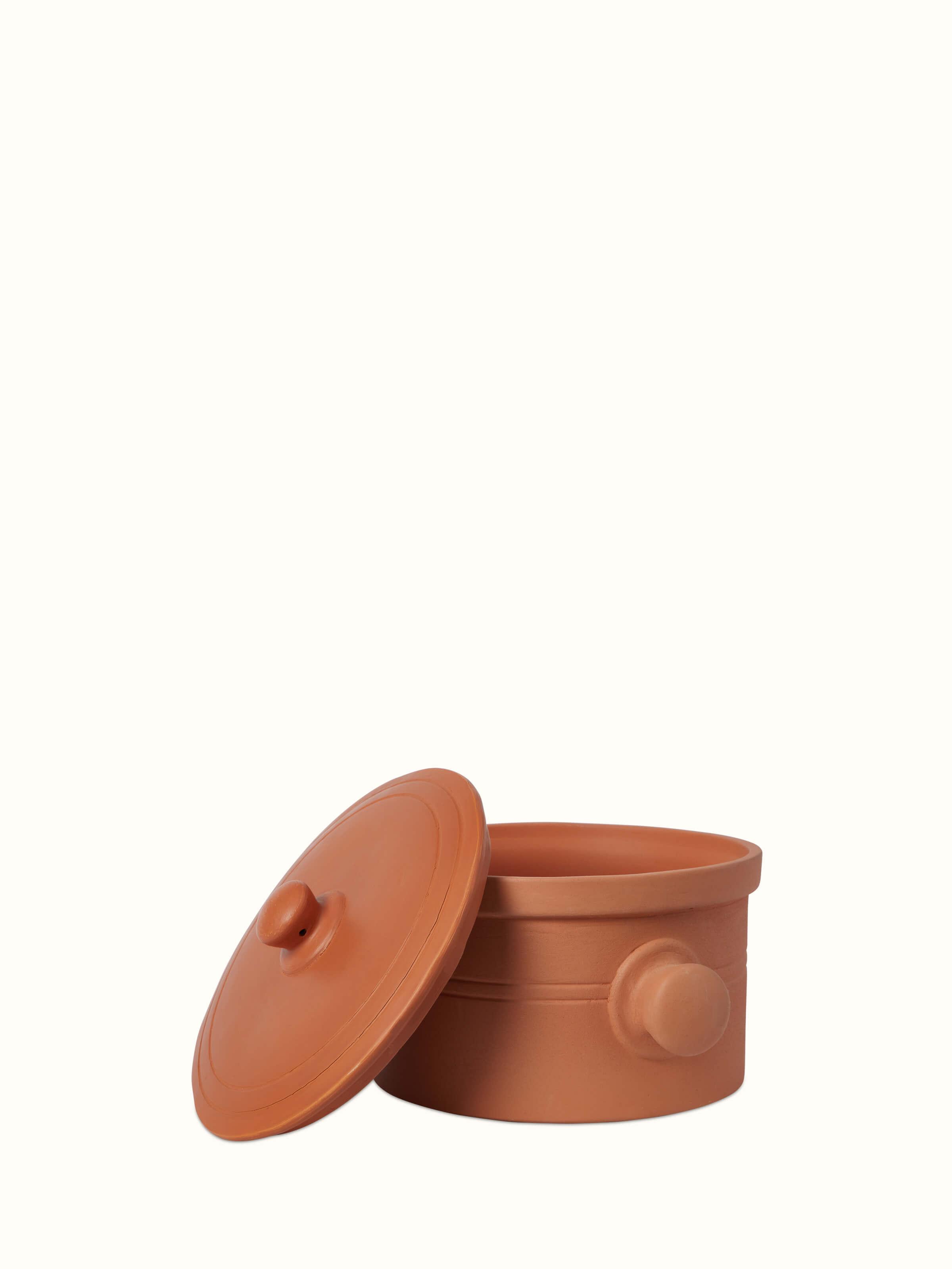 Side view of terracotta clay cooking pot, highlighting its rustic finish