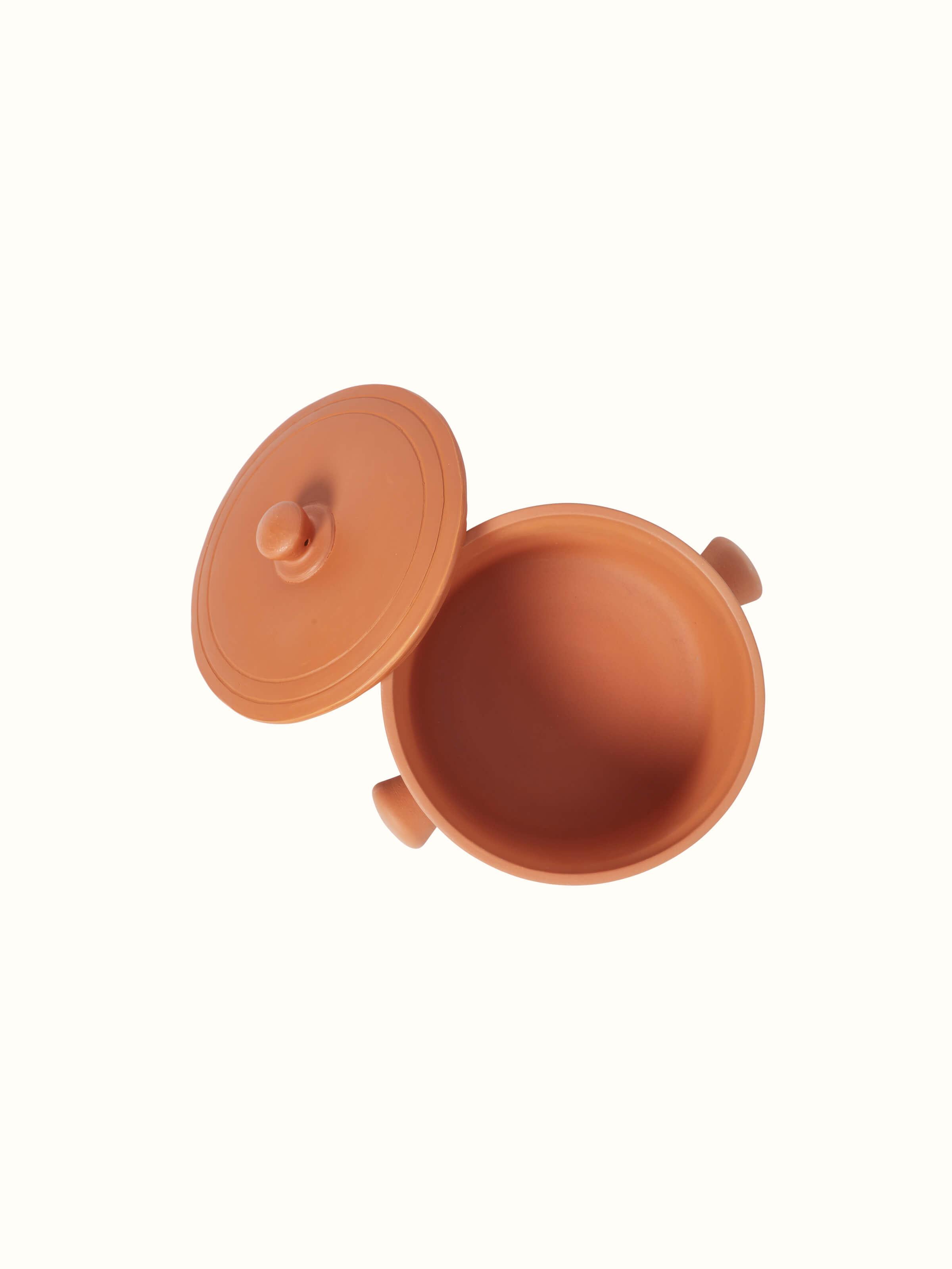 Detailed view of terracotta clay cooking pot, focusing on its texture and craftsmanship