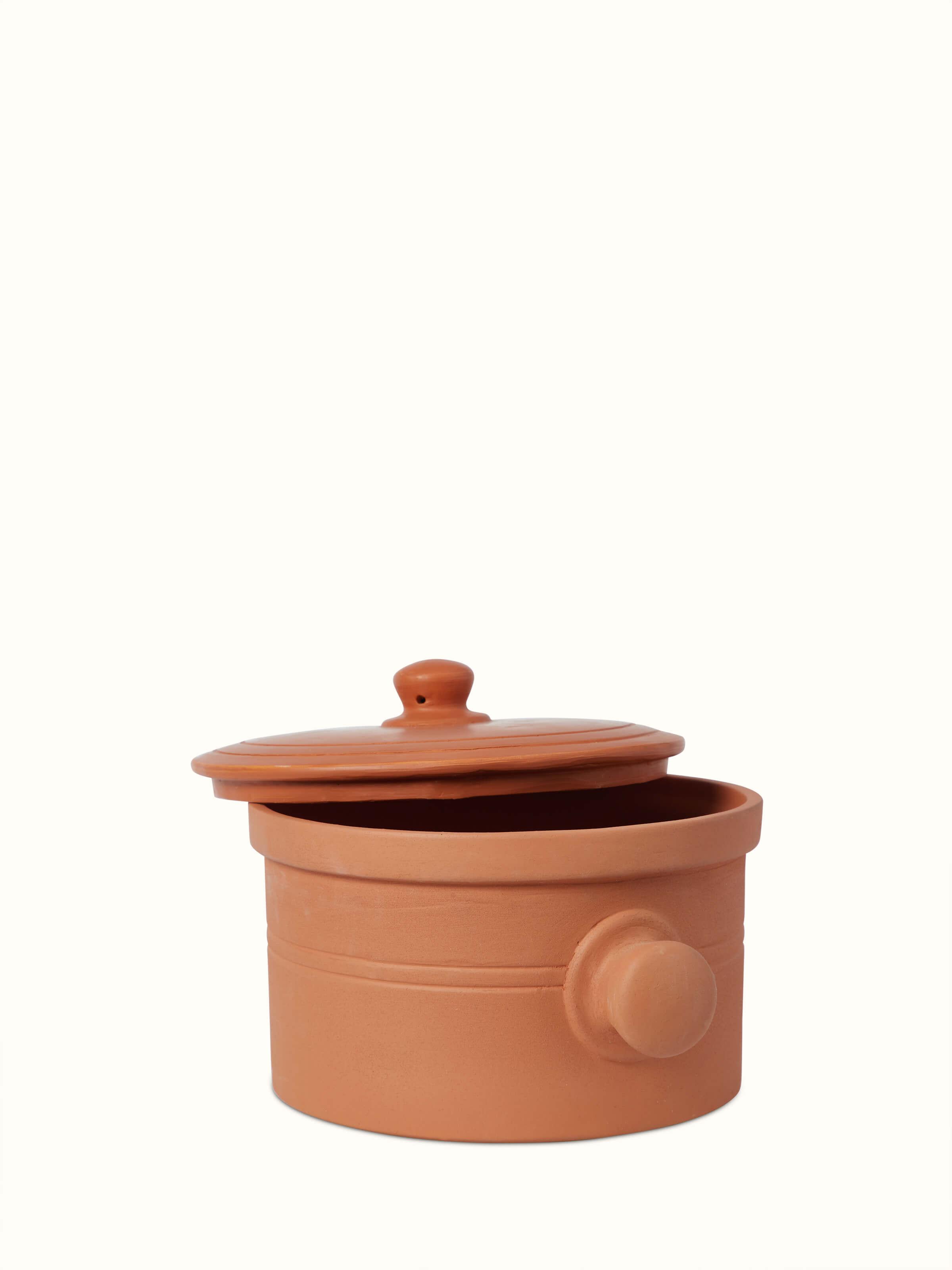 Angled view of terracotta clay cooking pot, highlighting its functional design