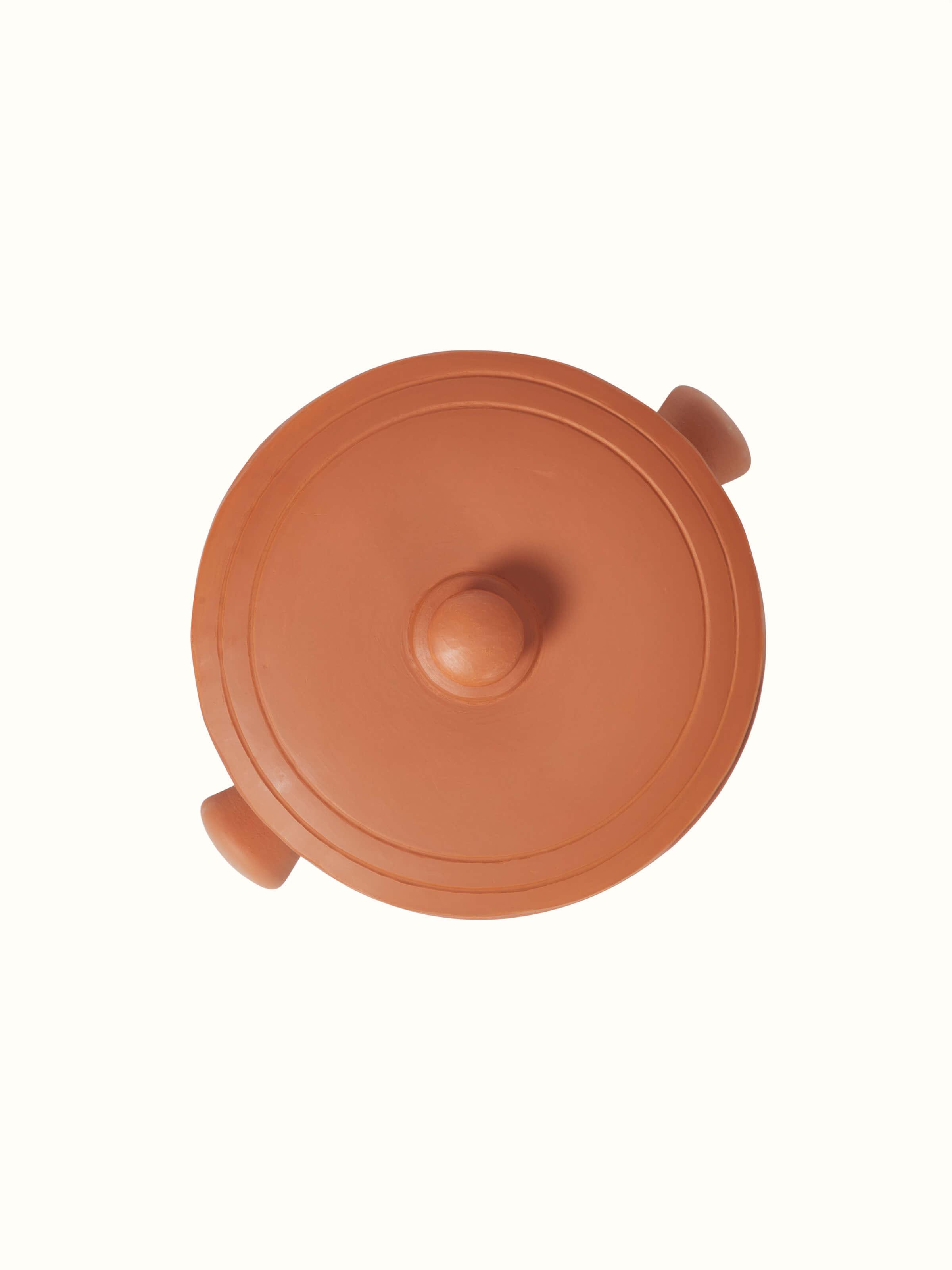 Close-up of terracotta clay cooking pot, emphasizing its artisanal features