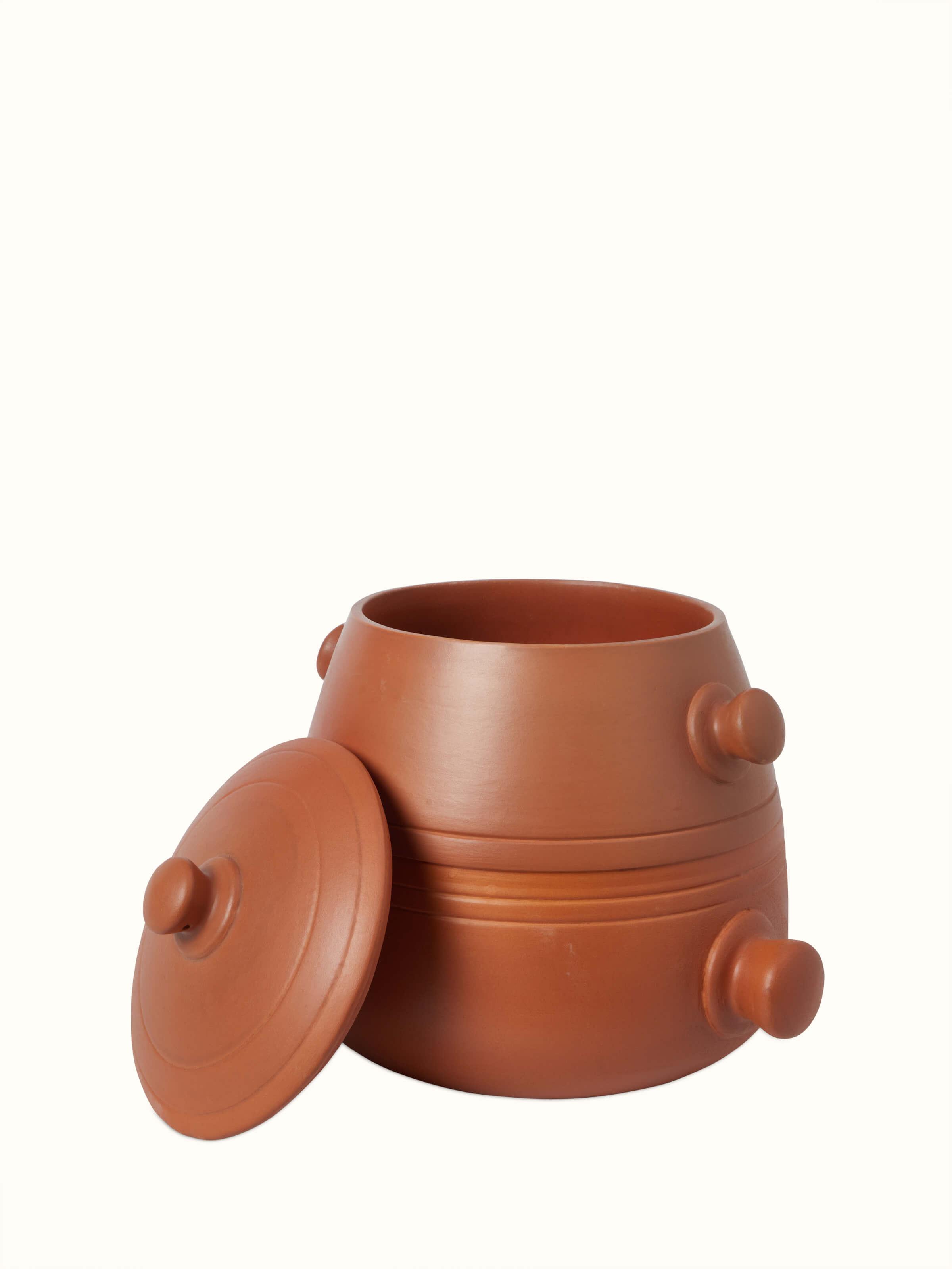 Front view of tall terracotta clay cooking pot with traditional design.