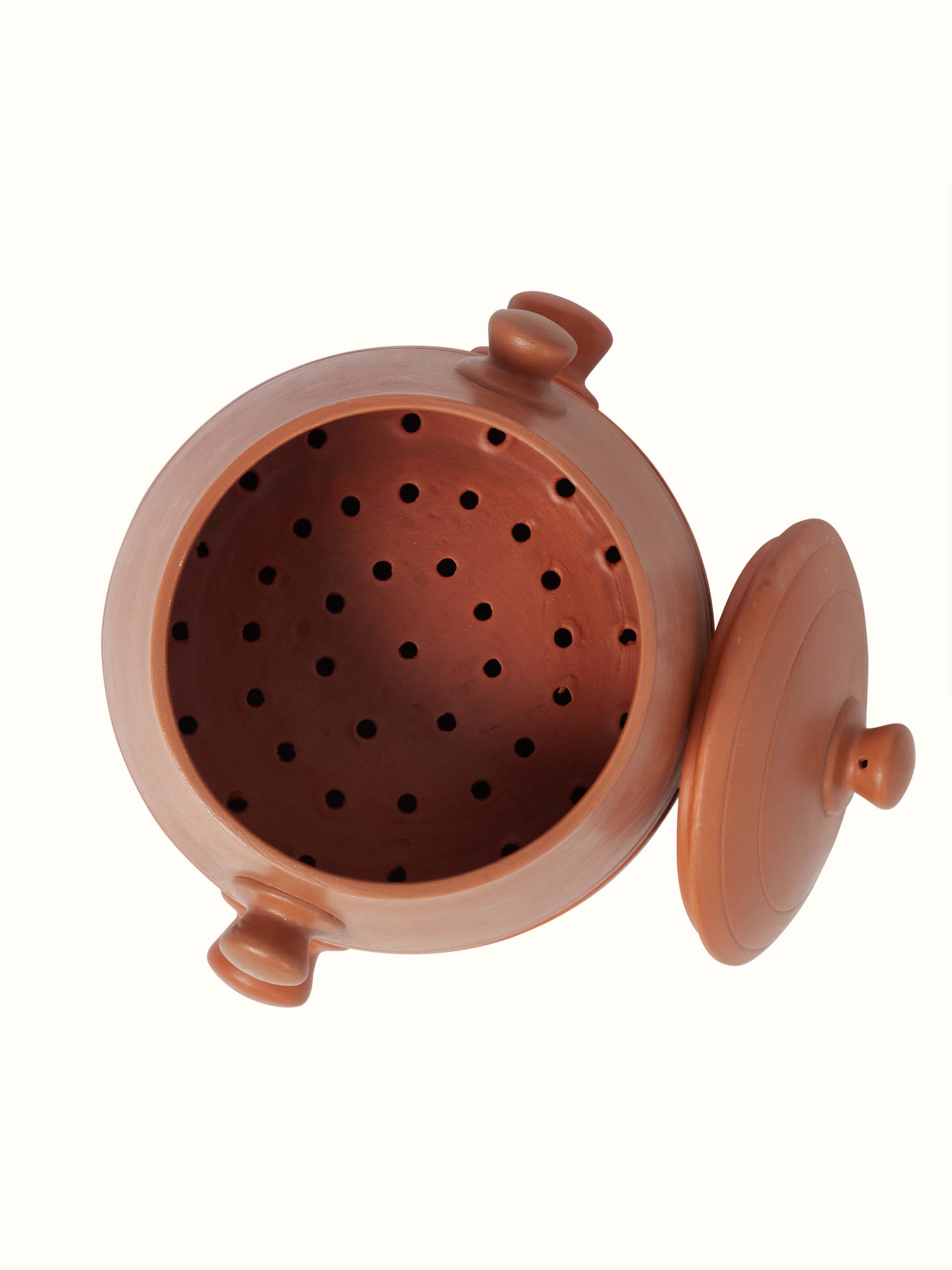 Detailed view of tall terracotta clay cooking pot showcasing its rich earthy color.