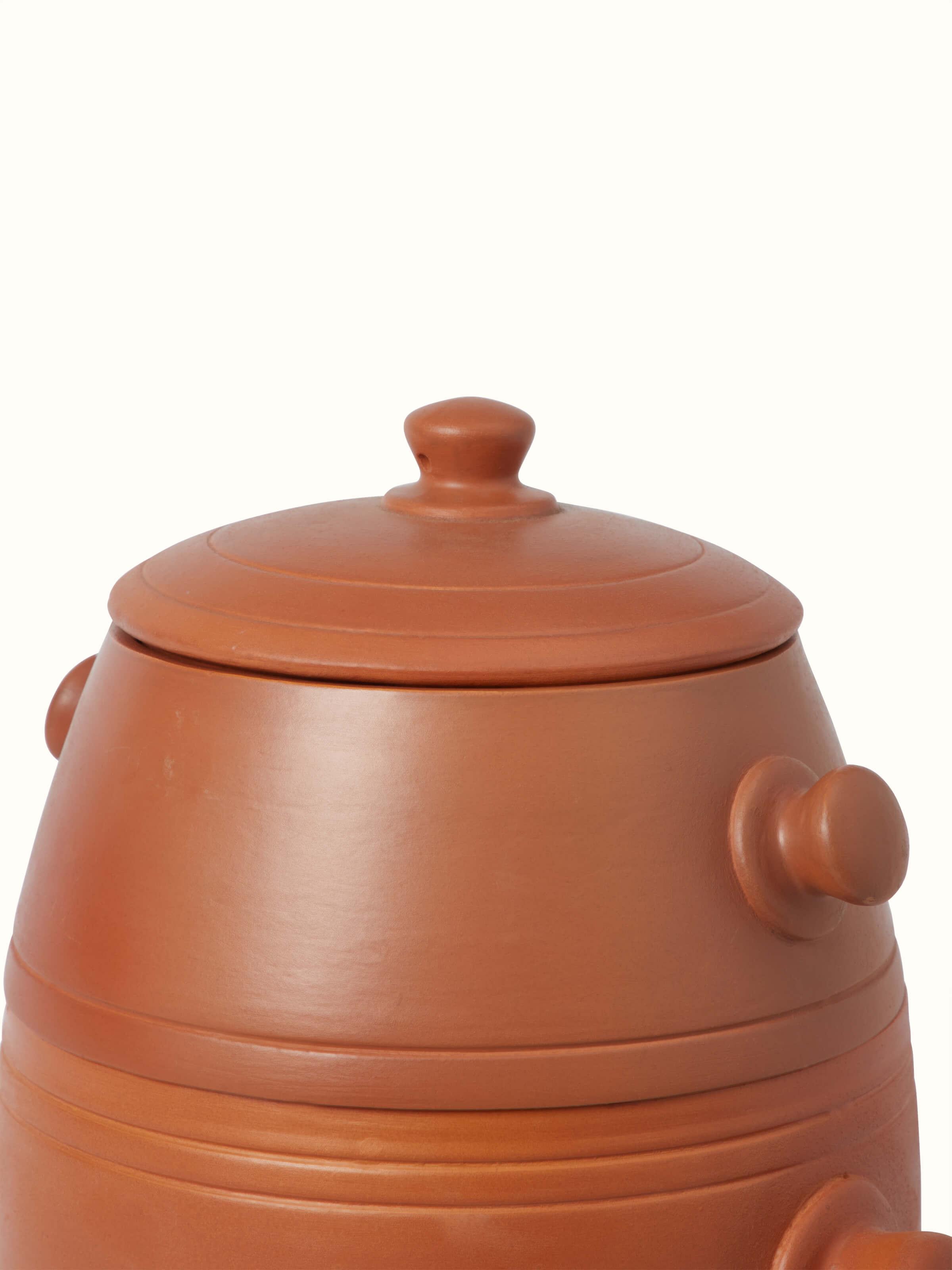 Top view of tall terracotta clay cooking pot revealing its classic shape and finish.
