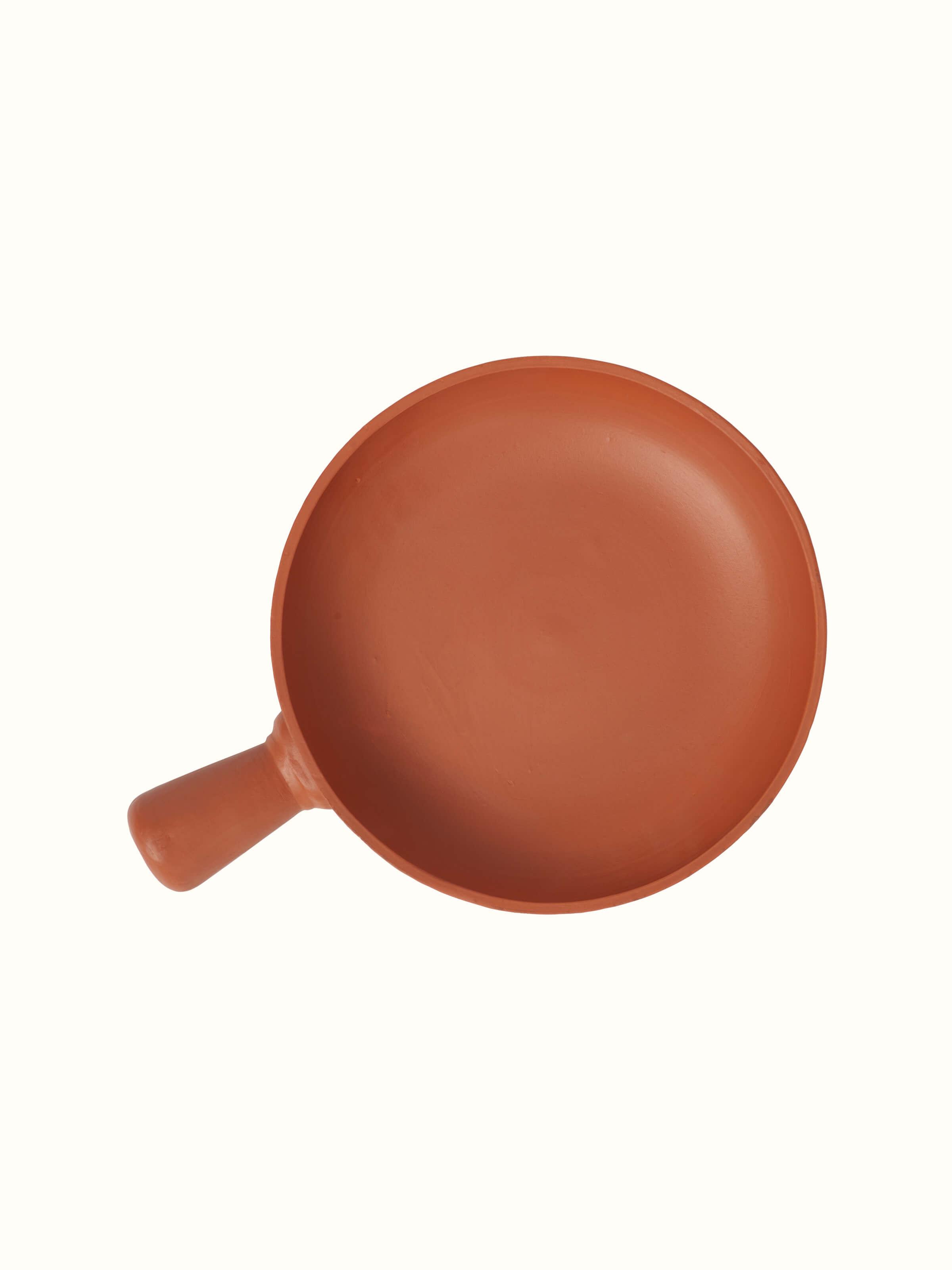 Top view of terracotta clay pan showing its smooth surface and traditional craftsmanship.