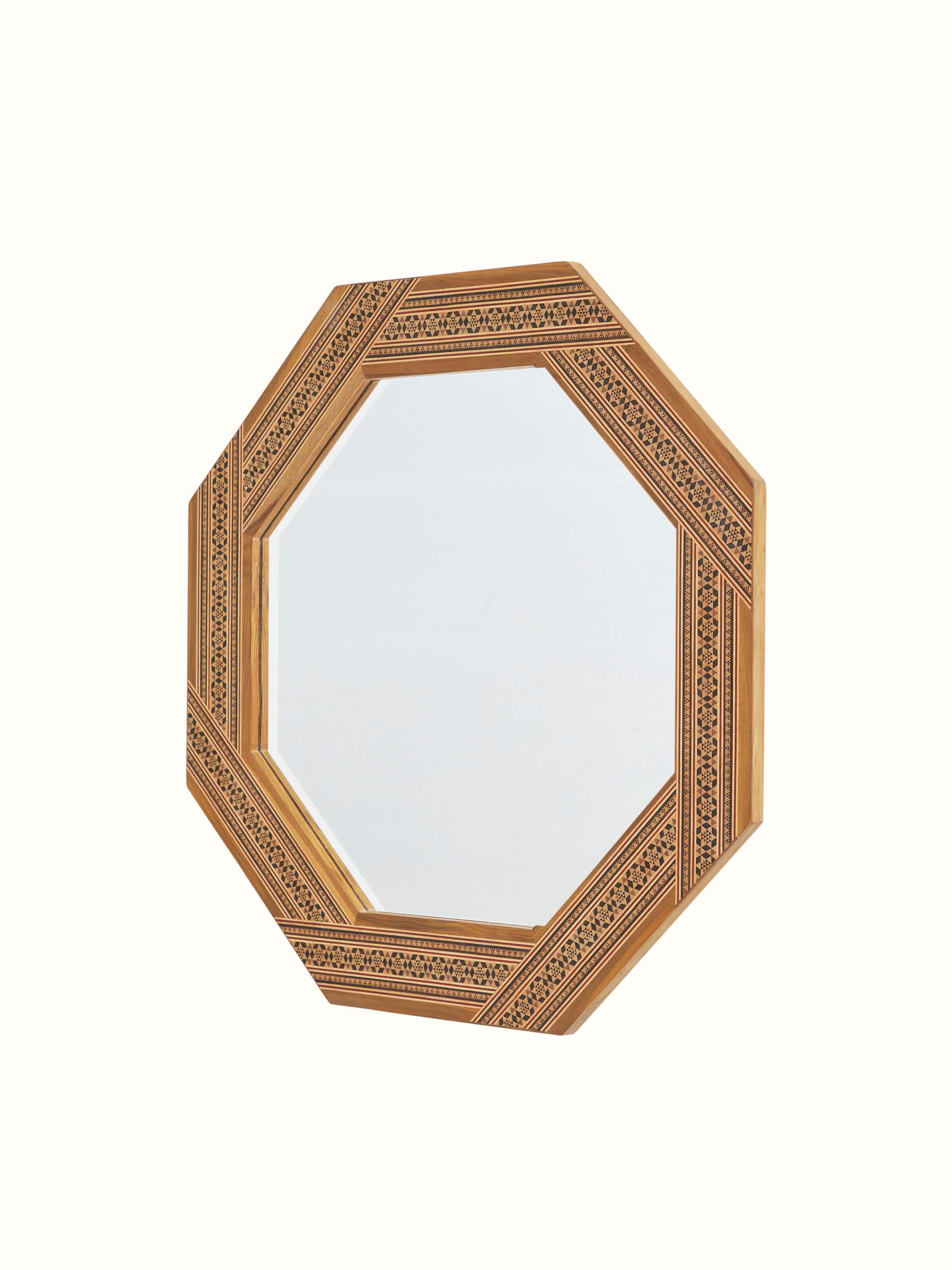 Close-up of the teak wood marquetry octagonal wall mirror, focusing on the detailed wood carving and inlay patterns.