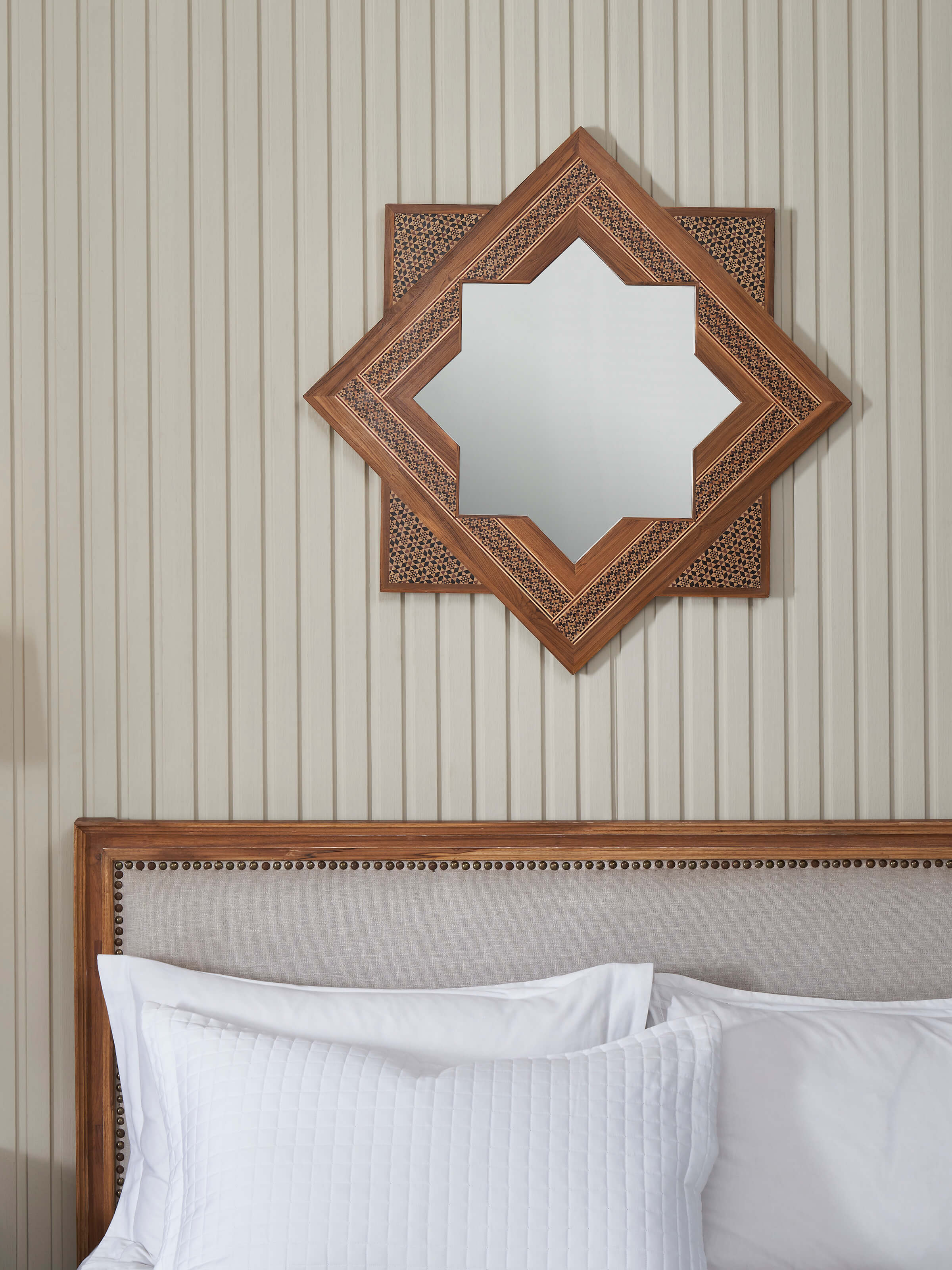 Side angle of the star-shaped teak wood marquetry wall mirror, showcasing the depth and craftsmanship of the design.