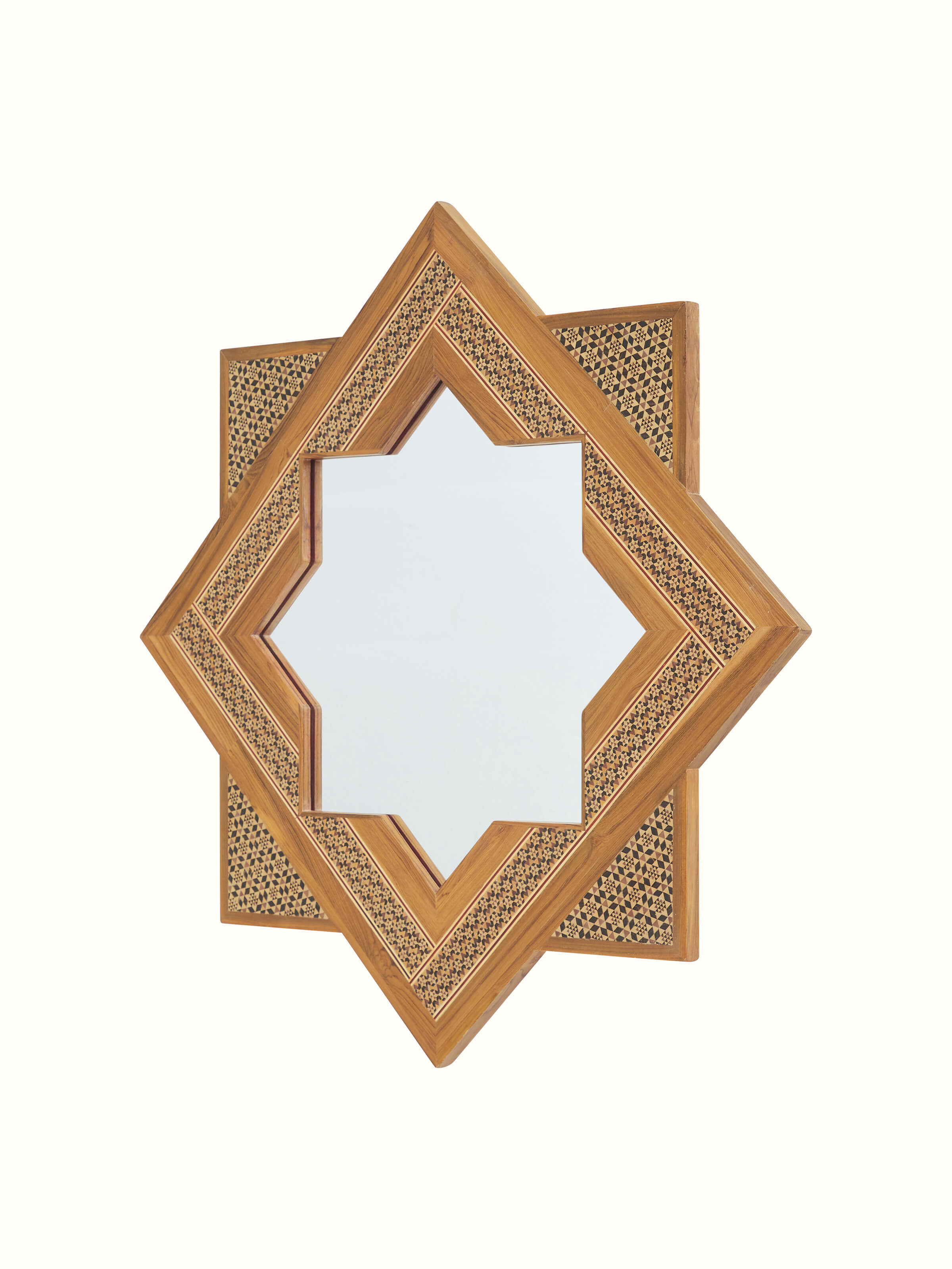 Close-up view of the marquetry details on the star-shaped teak wood wall mirror, emphasizing the fine craftsmanship.