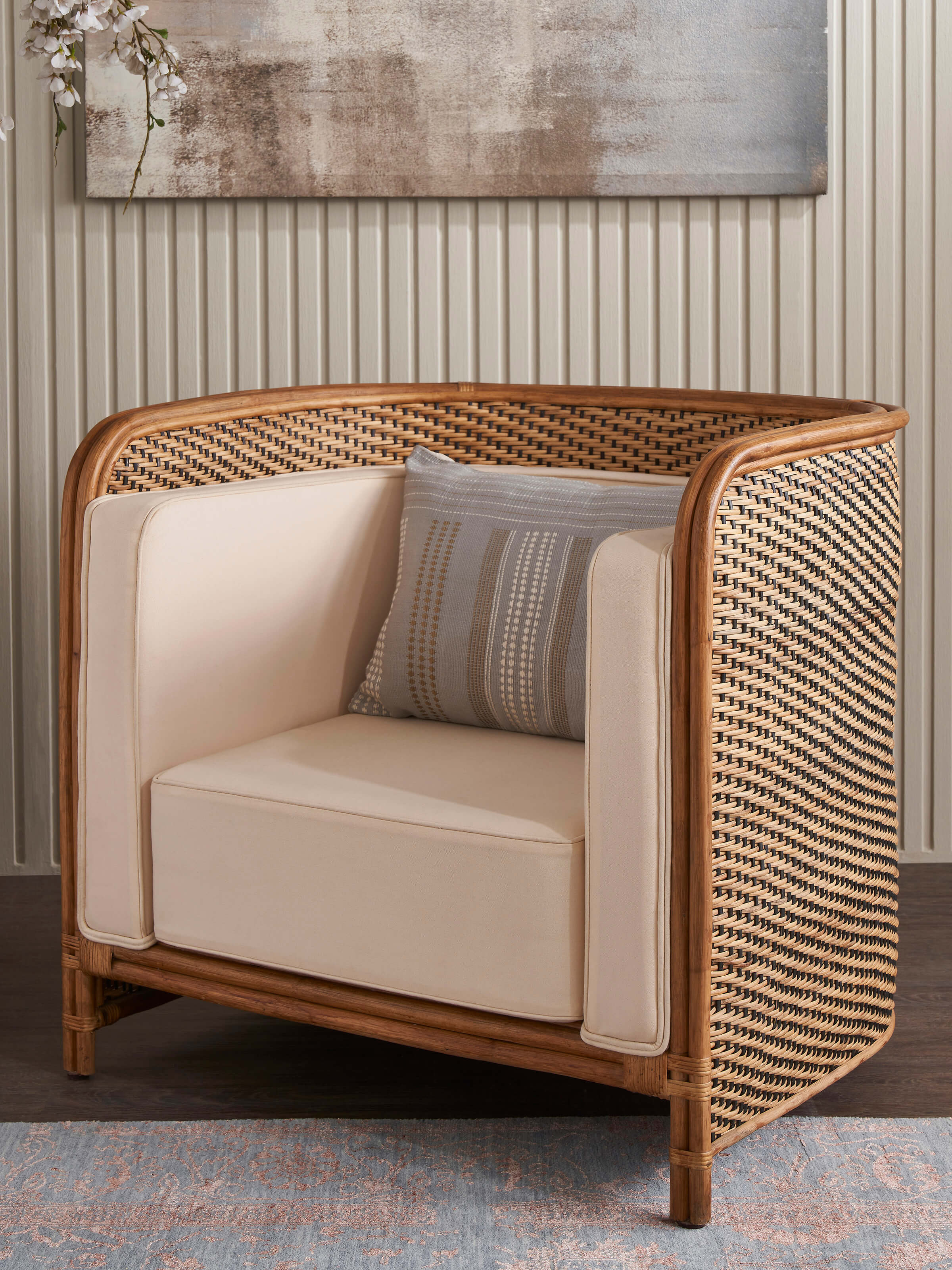 Side view of Upholstered Cane Armchair showcasing its armrest and cane weaving