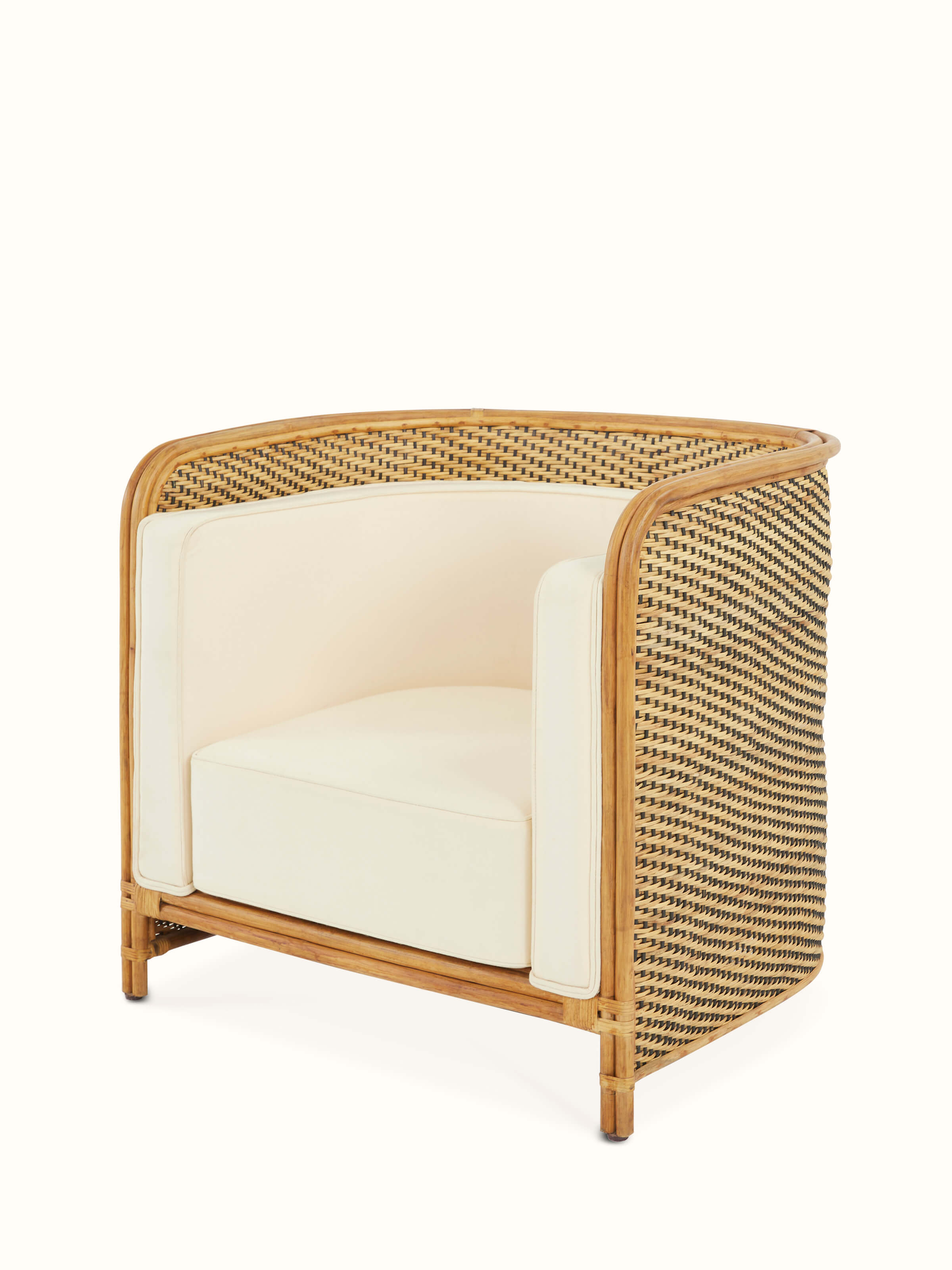 Angled view of Upholstered Cane Armchair emphasizing the rich upholstery and cane structure