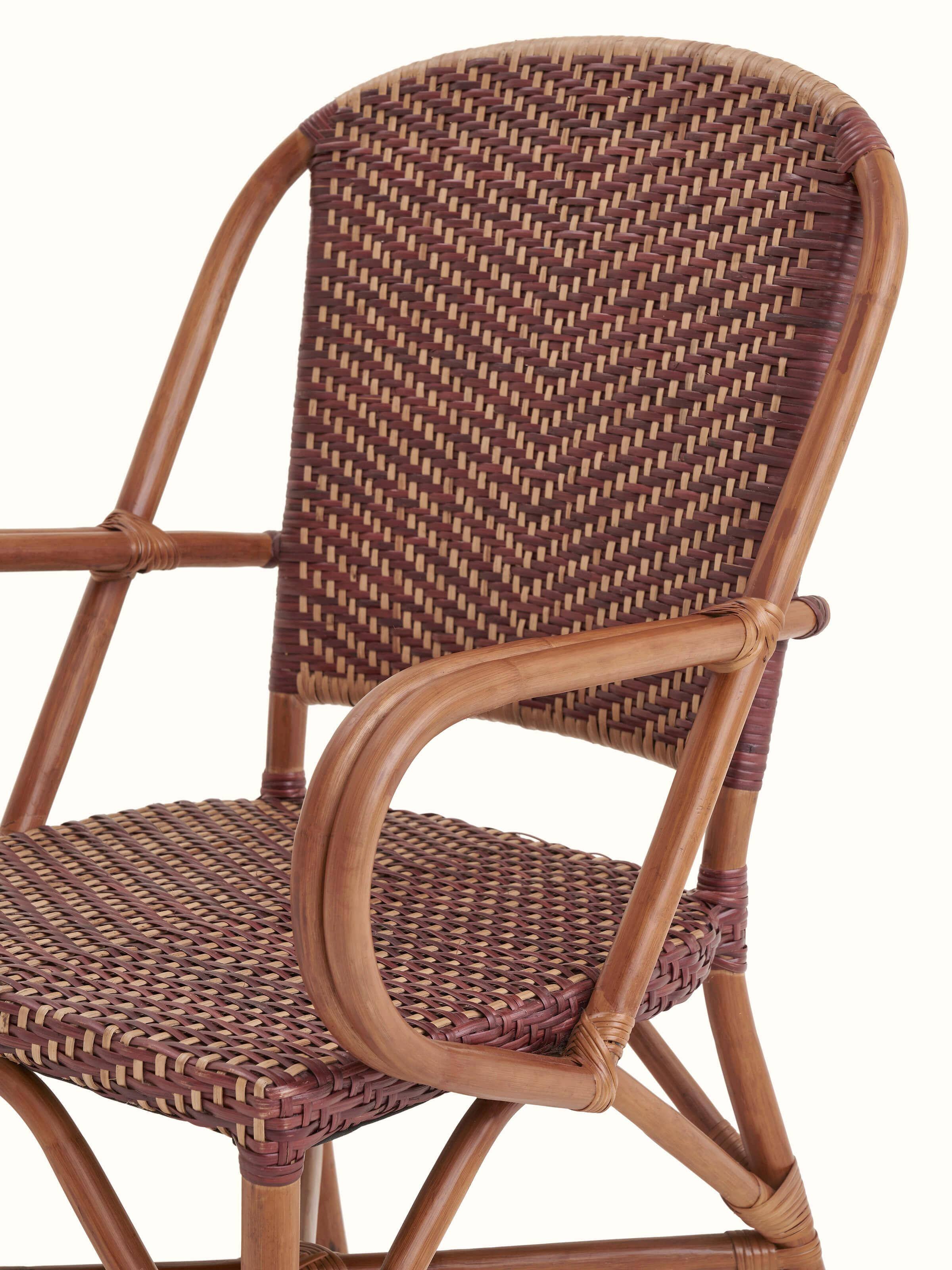 Angle view of the cane patio chair, displaying the seat and backrest design