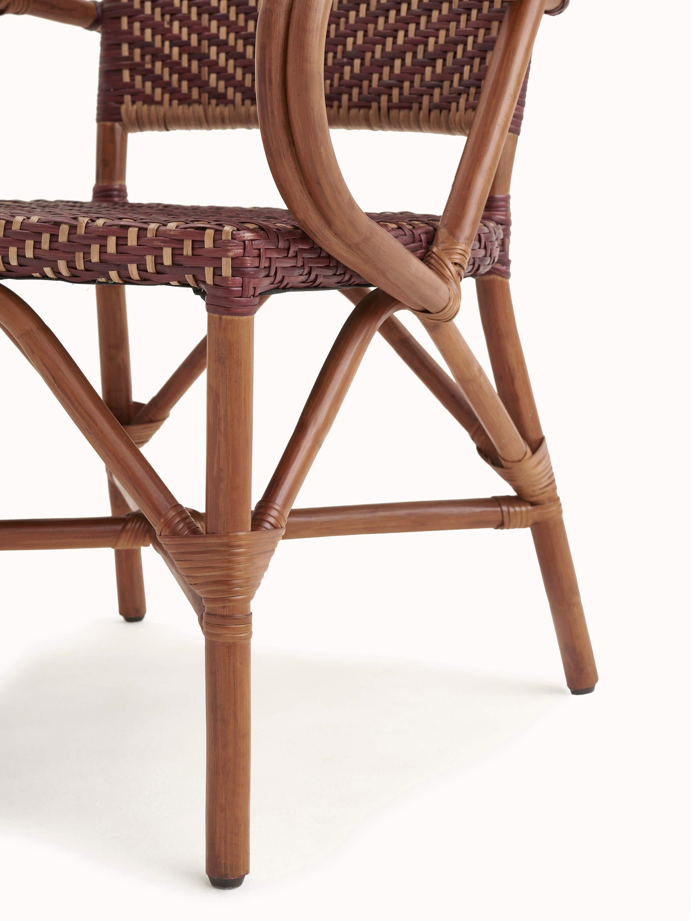 Close-up of the cane patio chair’s seat area, showing the comfort and design