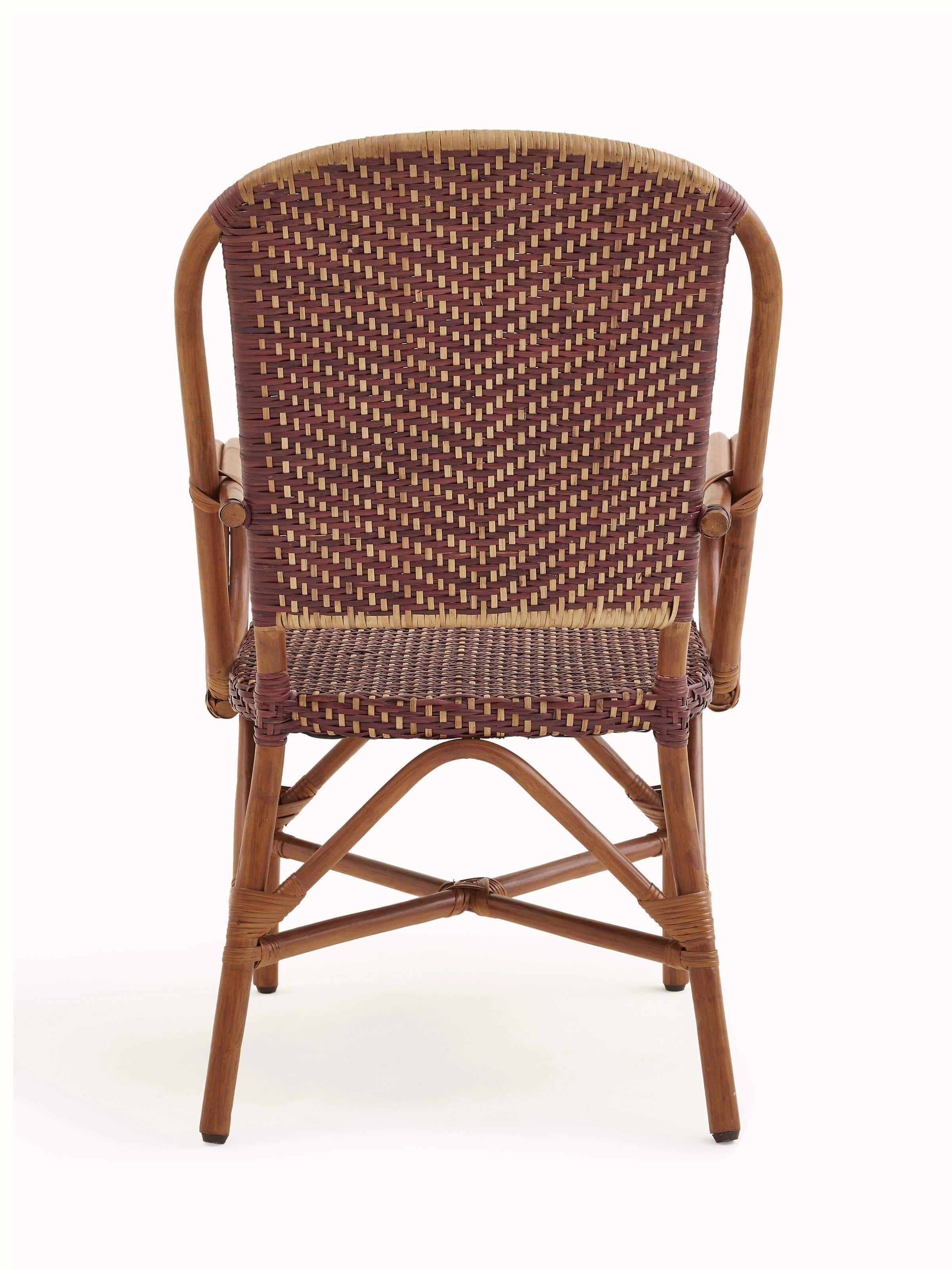 View of the cane patio chair from an angle, highlighting its overall design and aesthetics