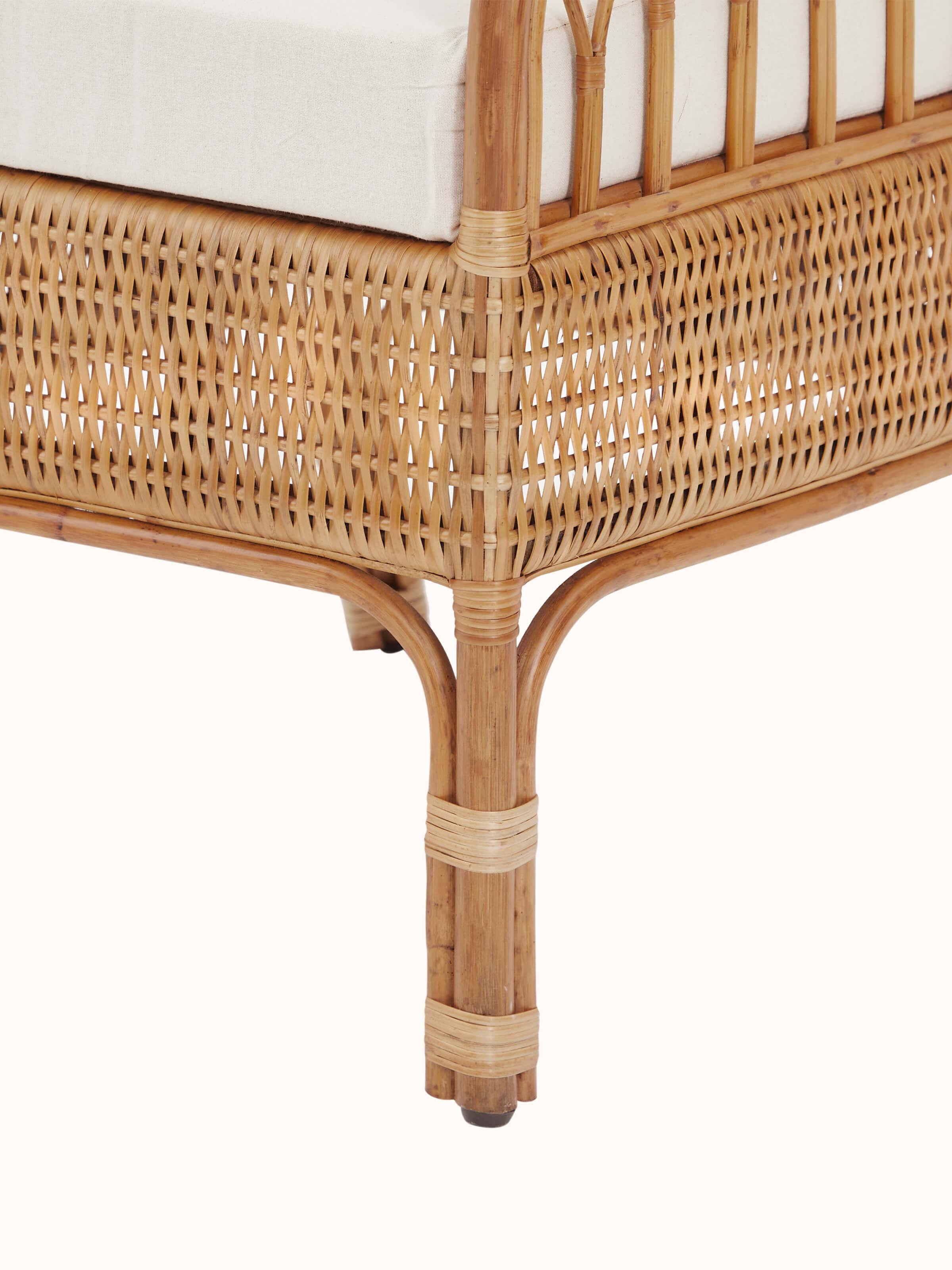Angled view of the upholstered cane study chair, emphasizing the combination of cane and fabric elements in its design.
