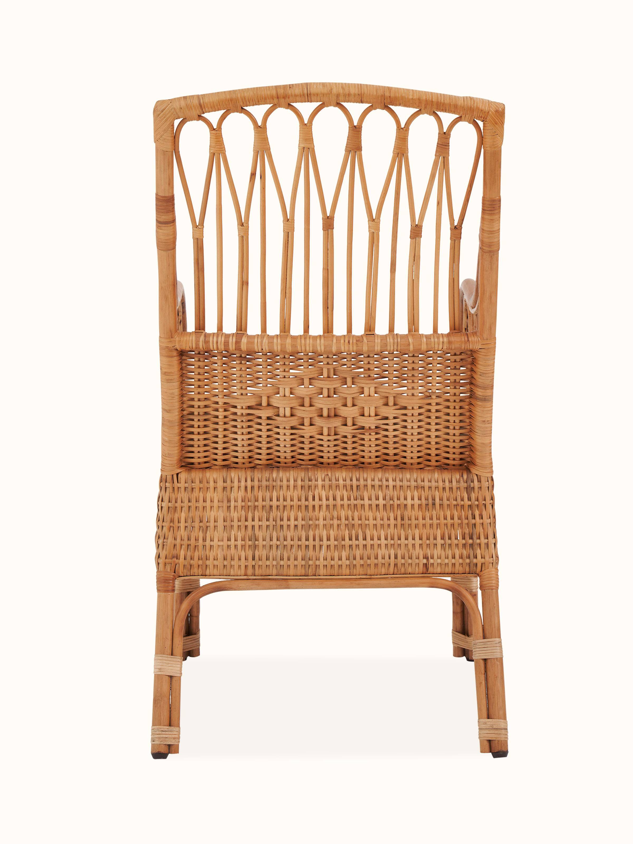 Detailed view of the upholstered cane study chair, highlighting the blend of cane and upholstery in its modern design.