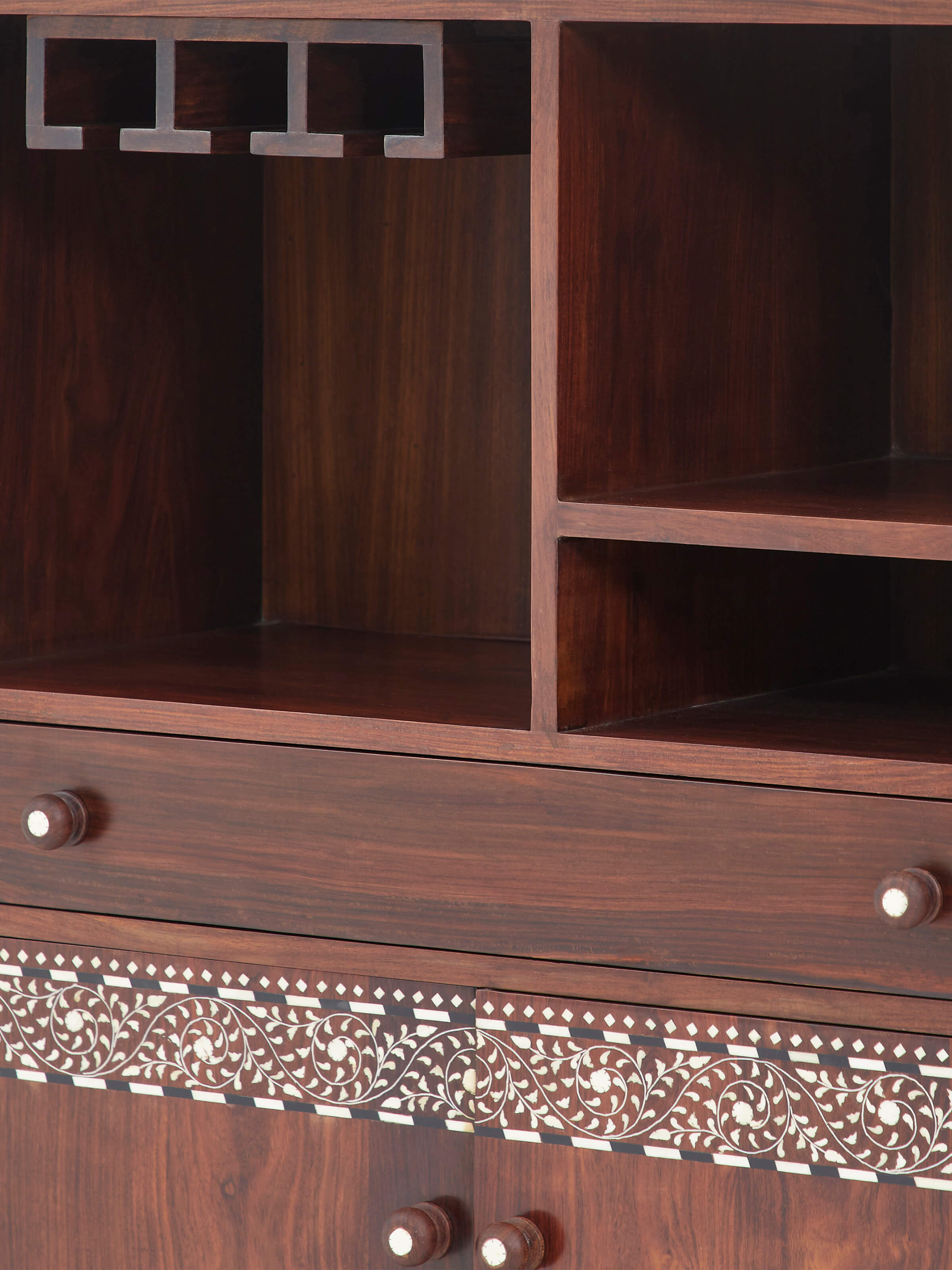 Detailed close-up of the Sheesham wood bar cabinet’s bone inlay patterns, focusing on the intricate craftsmanship