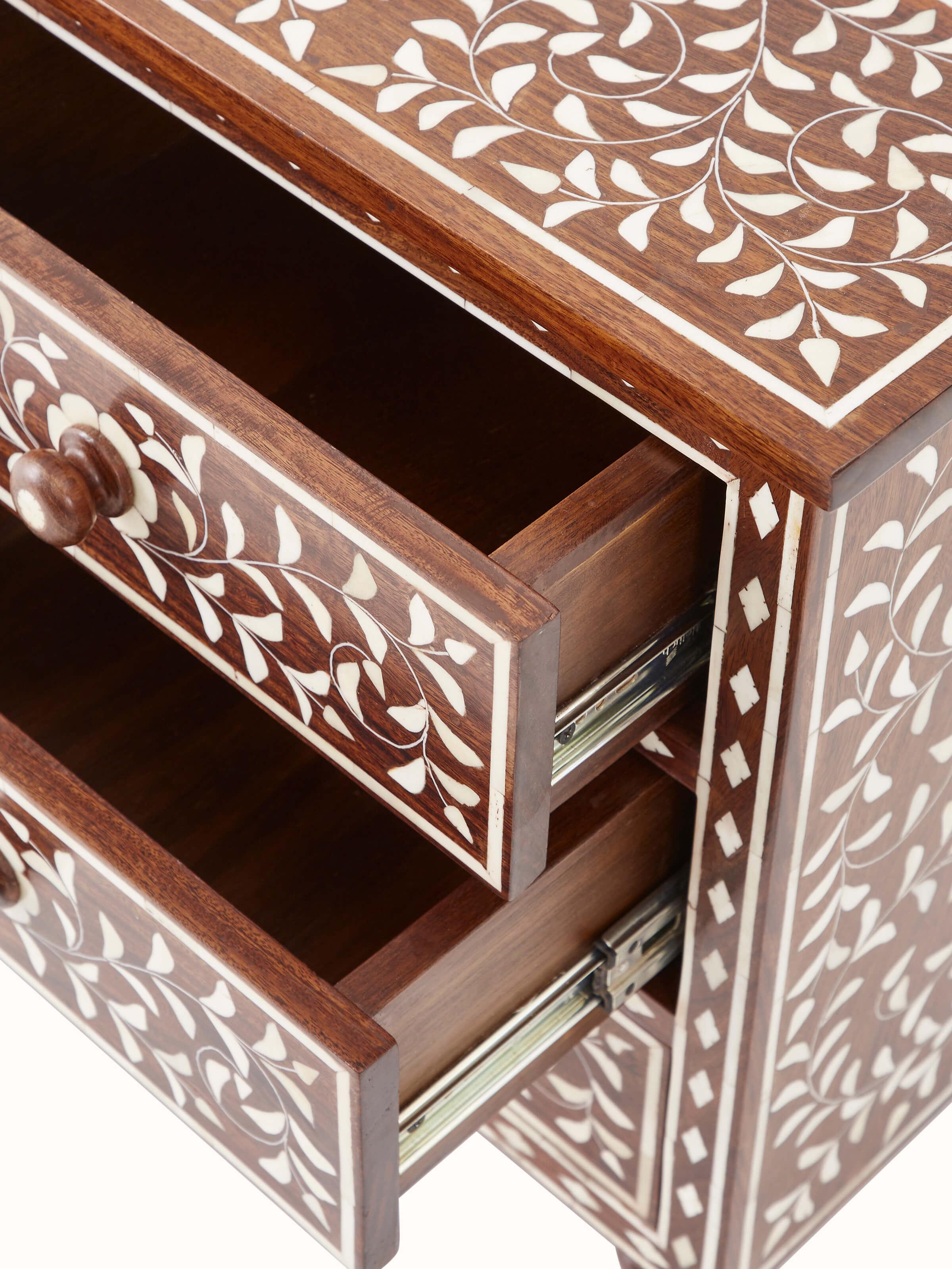 Close-up of Sheesham wood bone inlay bedside table leg, displaying intricate inlay work and sturdy design